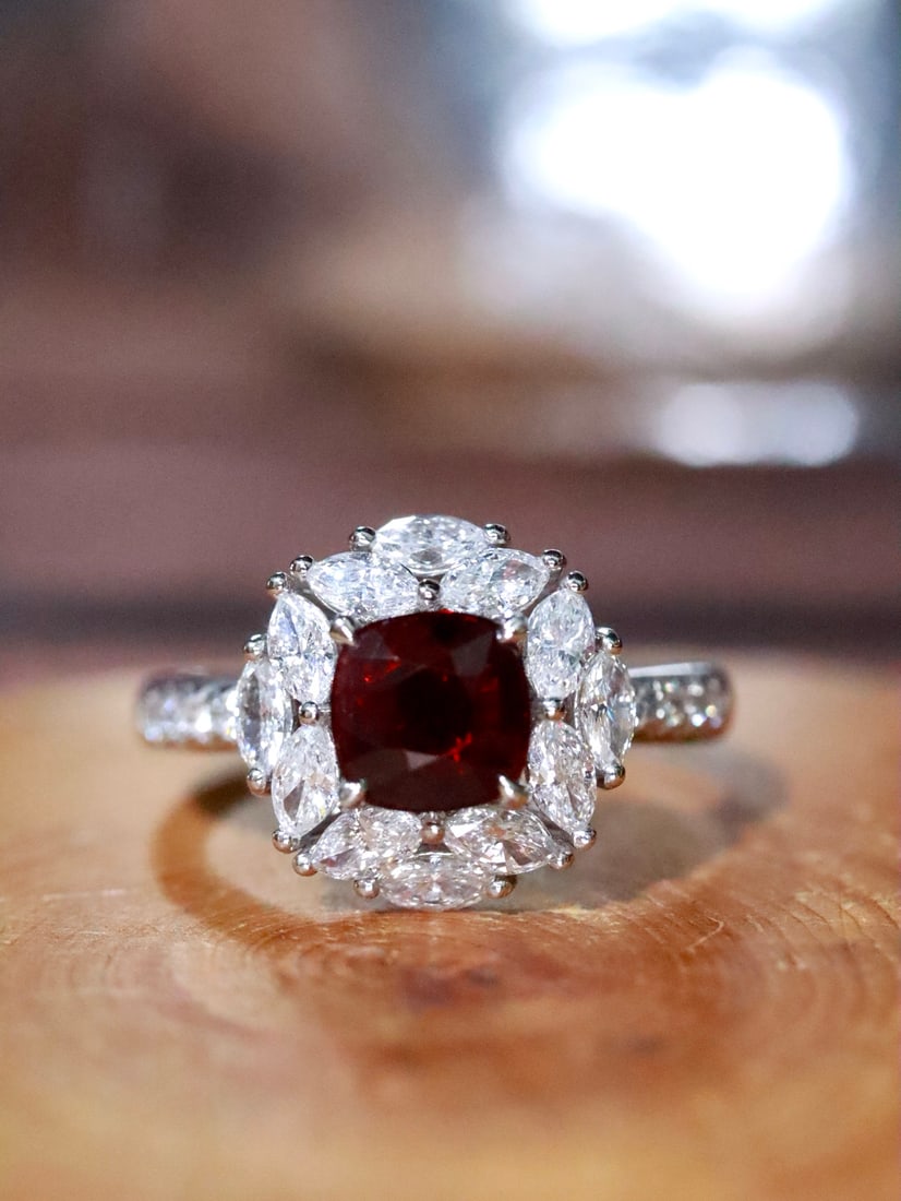 Platinum Natural Unheated Ruby Ring: This ring features an unheated Mozambique ruby as the main stone, showcasing a fiery hue with a gentle and delicate luster. The platinum setting adds a touch of nobility, while the diamond accents enh