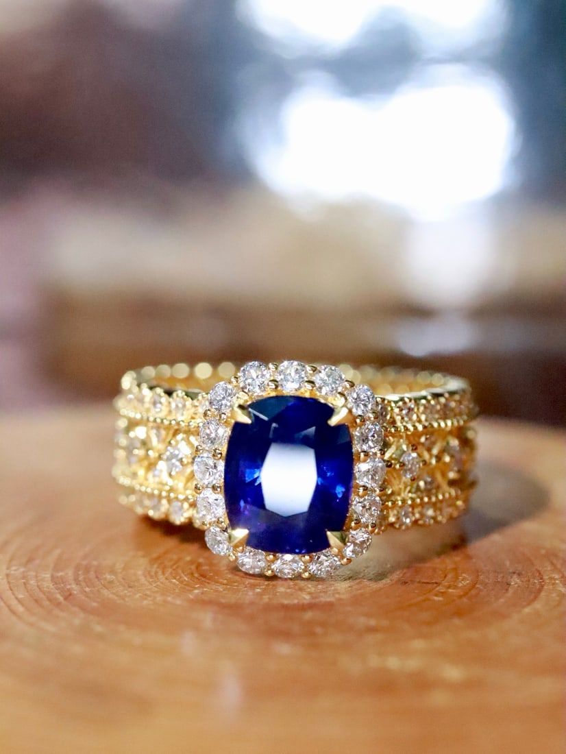 18K Gold Sapphire Ring: This ring is meticulously crafted in 18K gold, set with a dazzling sapphire that exudes a captivating brilliance. The addition of diamonds enhances its luxurious appeal, with an overall design that is