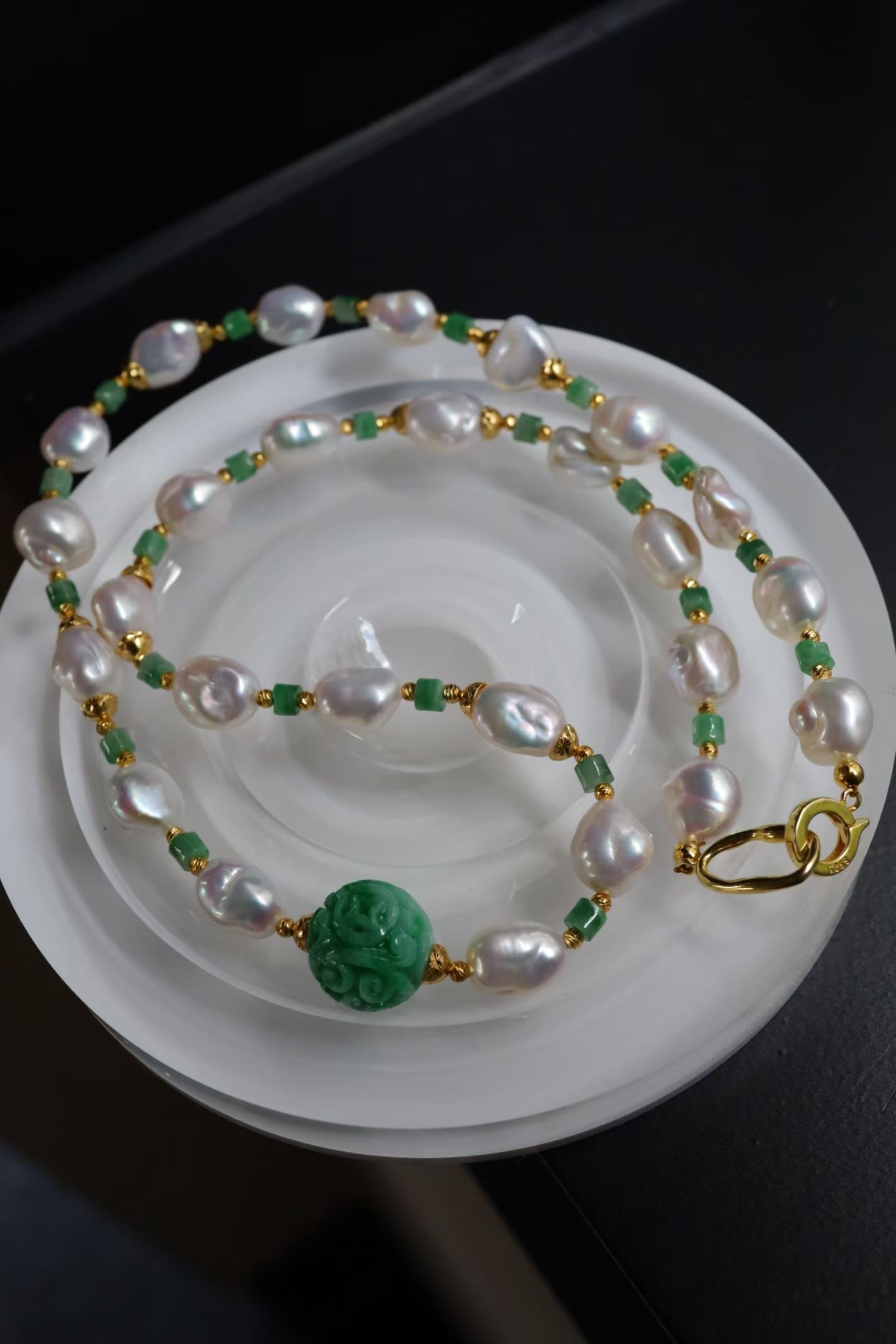 Sterling Silver Natural Jade Necklace: This necklace features a handcrafted pattern design that showcases the exquisite beauty of the Orient. The green hue of the jade flows gracefully along the collarbone, complemented by a sterling silve