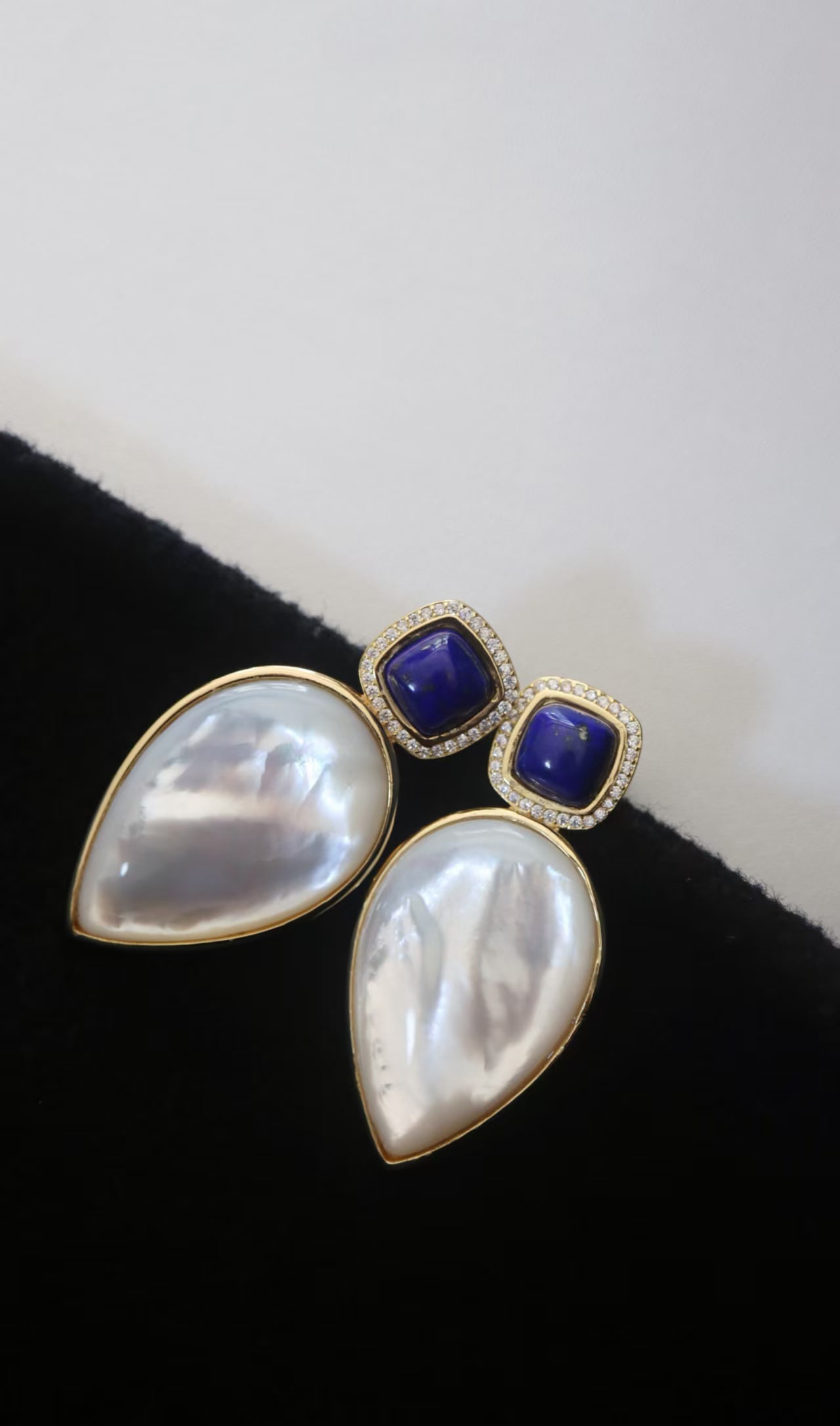 Natural Lapis Lazuli and White Mother-of-Pearl Earrings: These earrings perfectly combine the depth of natural lapis lazuli with the softness of white mother-of-pearl, showcasing an elegant harmony. The blue of the lapis lazuli complements the luster of the