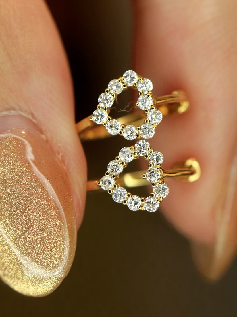 18K Gold Natural Diamond Earrings: These earrings are crafted in 18K gold, set with natural diamonds that exhibit a captivating white sparkle. The diamonds are exquisitely cut, shining brilliantly under light. Suitable for any occasion