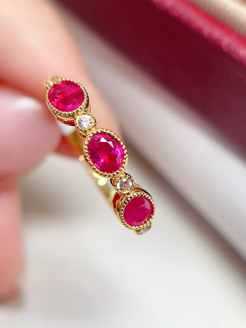 18K Gold Pigeon's Blood Red Ruby Ring: This 18K gold ring features a pigeon's blood red ruby with intense brilliance, showcasing extraordinary color allure. The band design adds a modern touch, exuding a sweet charm when worn. The ring is 