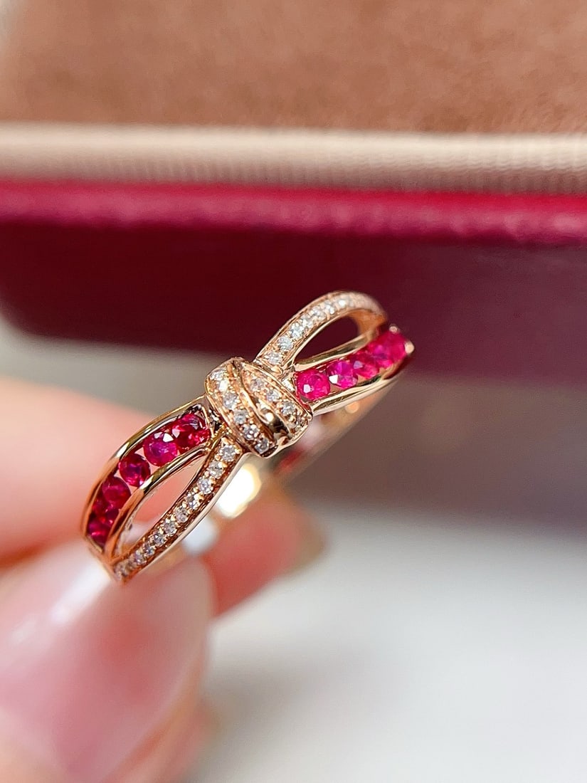 18K Gold Natural Unheated Ruby Ring: This ring is meticulously crafted in 18K gold, featuring a dazzling pigeon blood red ruby that exudes unparalleled elegance. The bezel-free setting, combined with a sweet bow design, adds a unique cha