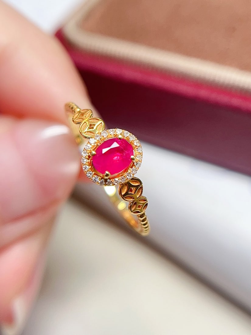 18K Gold Pigeon's Blood Red Ruby Ring: This ring is meticulously crafted in 18K gold, featuring a pigeon's blood red ruby with rich color and strong fluorescence. Surrounded by 18 diamonds, the design is elegant yet luxurious. (Main stone