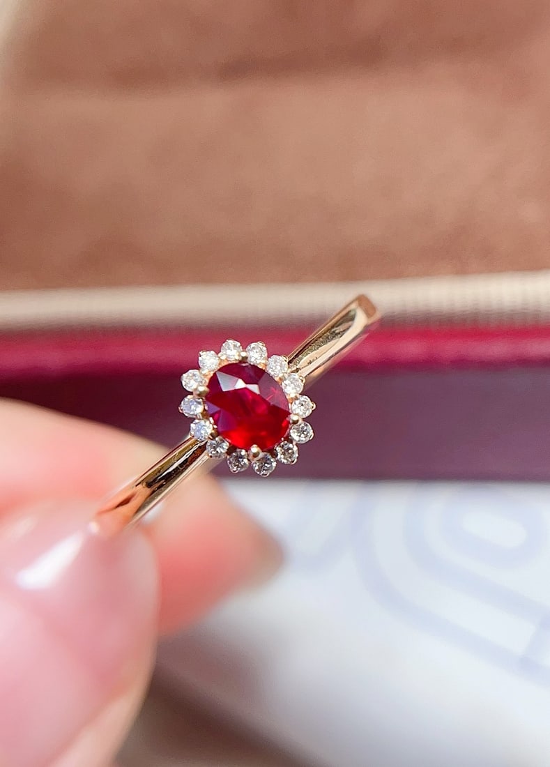 18K Gold Pigeon's Blood Red Ruby Ring: This 18K gold ring features a pigeon's blood red ruby with rich color and flawless clarity. The classic Lady Di design exudes elegance and nobility. Complemented by 14 diamonds, it is both exquisite