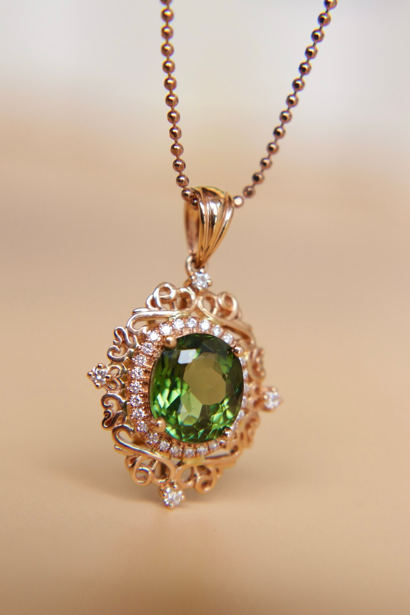 18K Gold Green Tourmaline Diamond Pendant: This pendant is meticulously crafted in 18K gold, featuring a captivating green tourmaline complemented by sparkling diamonds, embodying a perfect blend of luxury and elegance. Its exquisite design