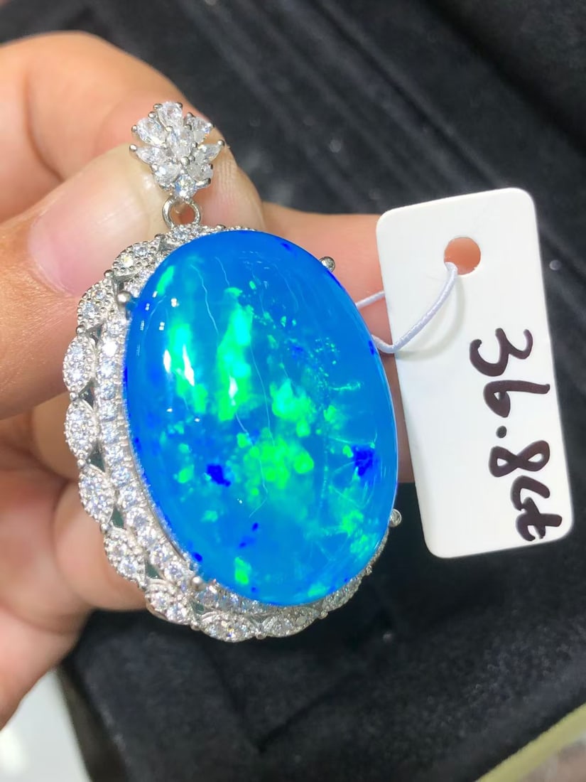 Natural Colorful Blue Opal Pendant: This natural colorful blue opal pendant captivates every wearer with its unique colors and luster. The main stone weighs 36.8 carats, showcasing unparalleled natural beauty. Expertly set in S925 sterl