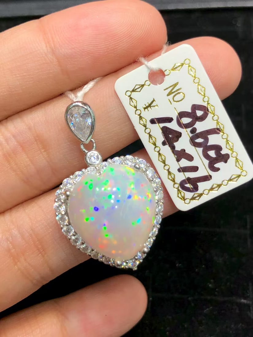 Natural Colorful Opal Pendant: This natural colorful opal pendant captivates with its unique heart shape and dazzling colors, showcasing unparalleled craftsmanship and design. The size and weight of the main stone make it a rare