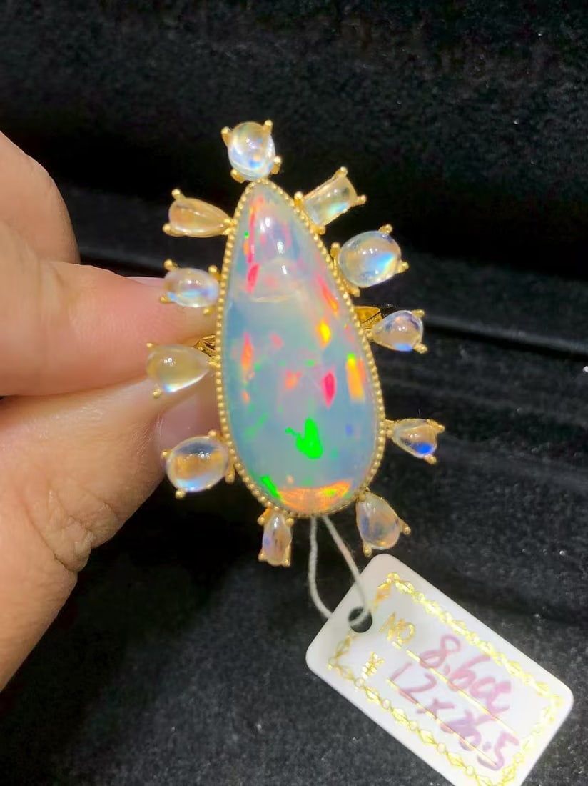 Natural Colorful Opal Ring: This custom-made natural colorful opal ring features a dazzling main stone that showcases unique brilliance and charm. Expertly set in S925 sterling silver, it perfectly blends modern design with