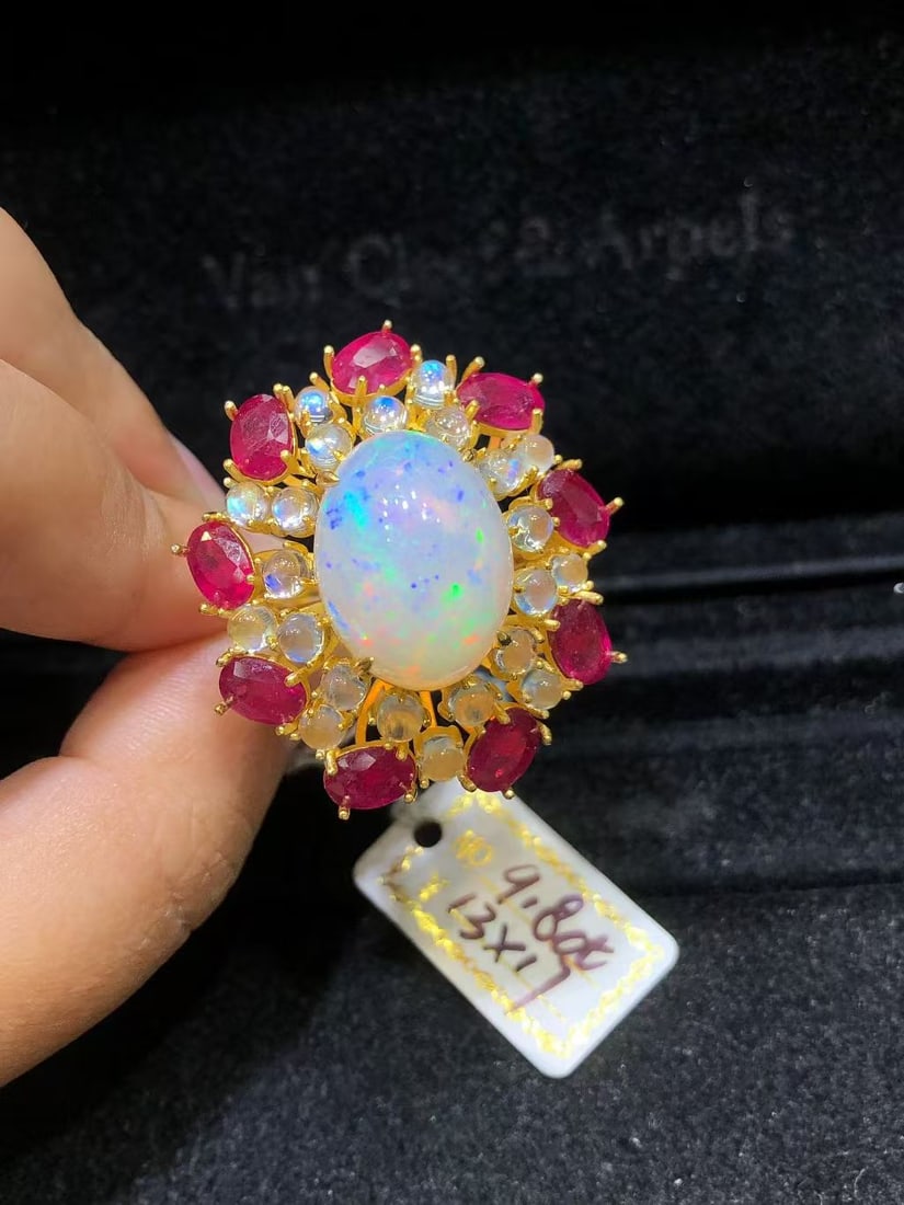 Natural Colorful Opal Ruby Blue Moonstone Ring: This custom ring features a blend of natural colorful opal, ruby, and blue moonstone, showcasing a unique brilliance and charm. The exquisite setting of the main and accent stones highlights the