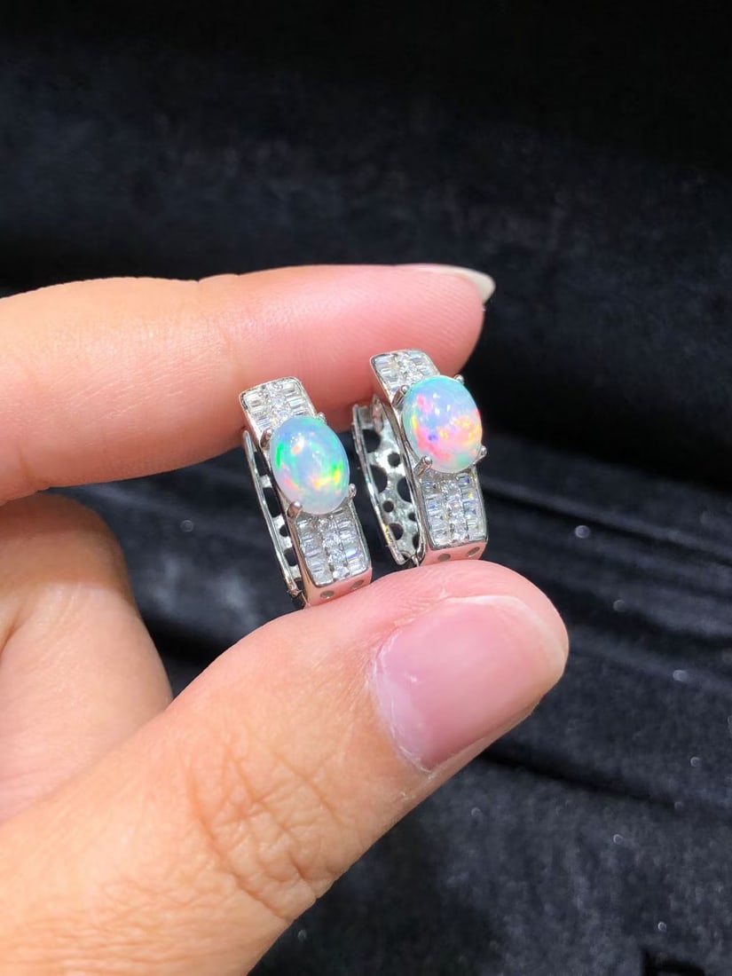 Natural Opal Earrings: These natural opal earrings captivate every wearer with their unique colors and luster. The main stone measures 7*5mm and is intricately set in S925 sterling silver, showcasing a perfect blend of