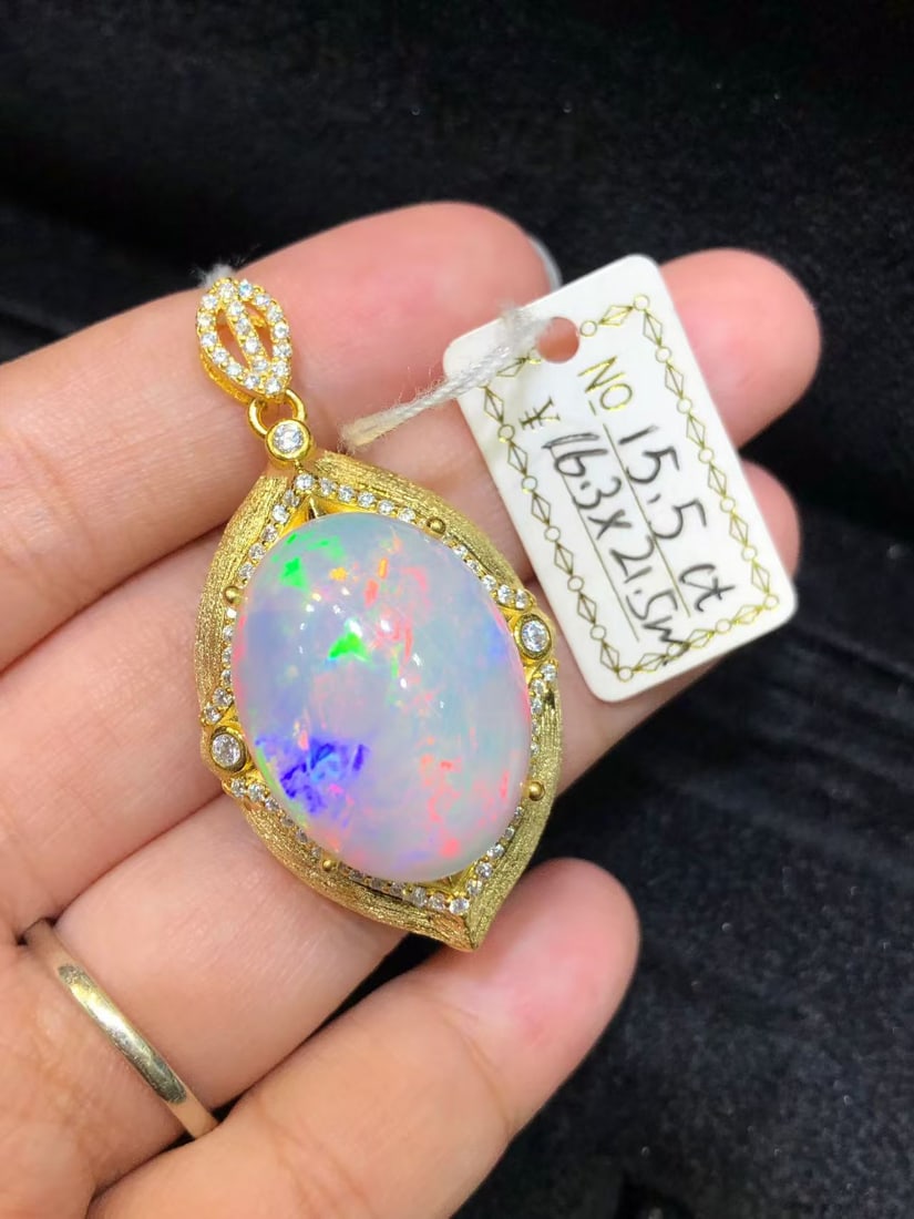 Natural Colorful Opal Pendant: This pendant features a natural colorful opal as the main stone, showcasing its unique brilliance and charm. Expertly set in S925 sterling silver, it perfectly blends modern design with classic