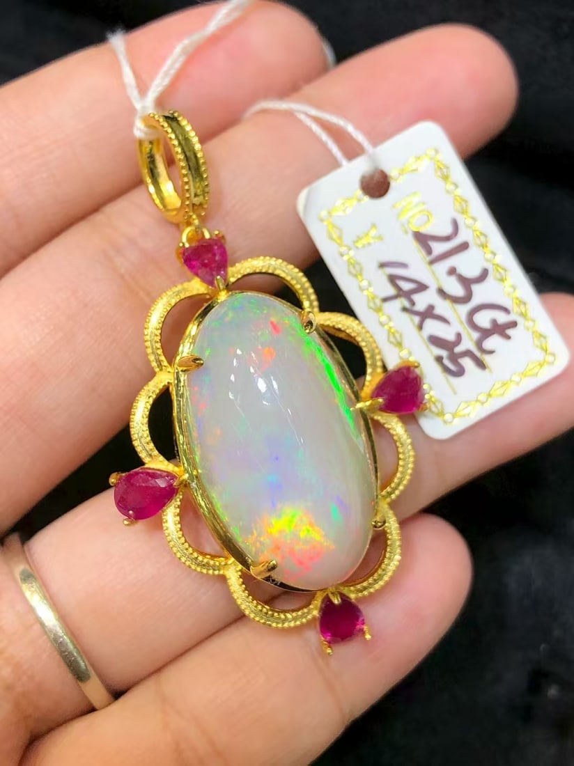Natural Colorful Opal Ruby Pendant: This pendant features a natural colorful opal as the main stone, complemented by rubies, showcasing a unique brilliance and charm. Expertly set in S925 sterling silver, it exudes a luxurious aura. (Ma