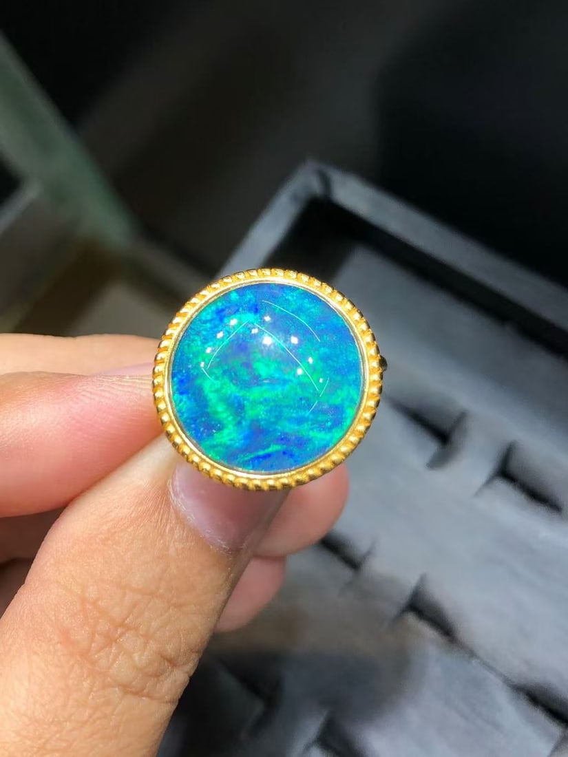 Natural Opal Ring: This natural opal ring captivates every wearer with its unique colors and luster. The main stone measures 15mm, showcasing unparalleled natural charm. Expertly set in S925 sterling silver, it exudes e