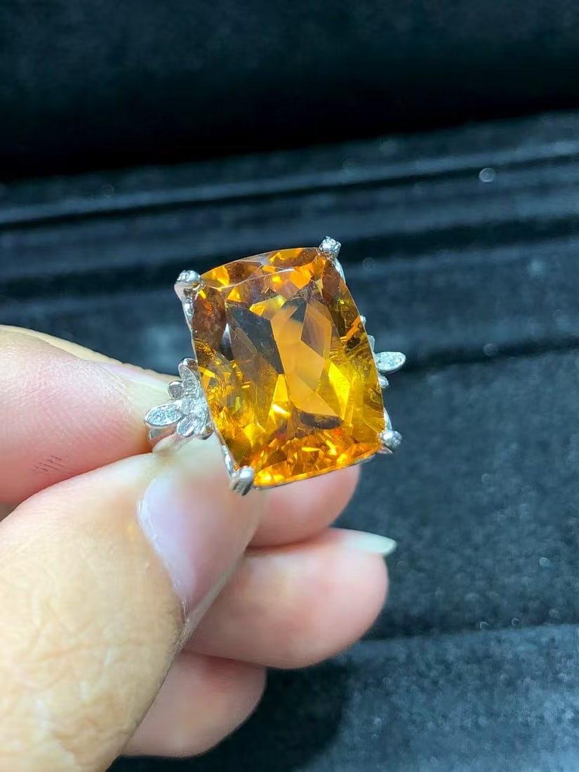 Natural citrine ring: This ring features a natural citrine as its center stone, showcasing its unique luster and color. It is meticulously set in S925 sterling silver, exuding elegance and luxury. The center stone
