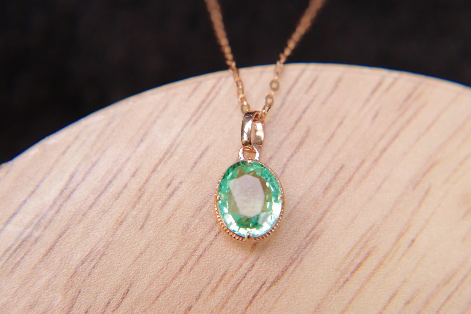 18K Gold Natural Emerald Pendant: This pendant is meticulously crafted in 18K gold, set with a natural emerald that exudes a noble and elegant aura. The deep and enchanting hue of the emerald perfectly complements the wearer's gracefu