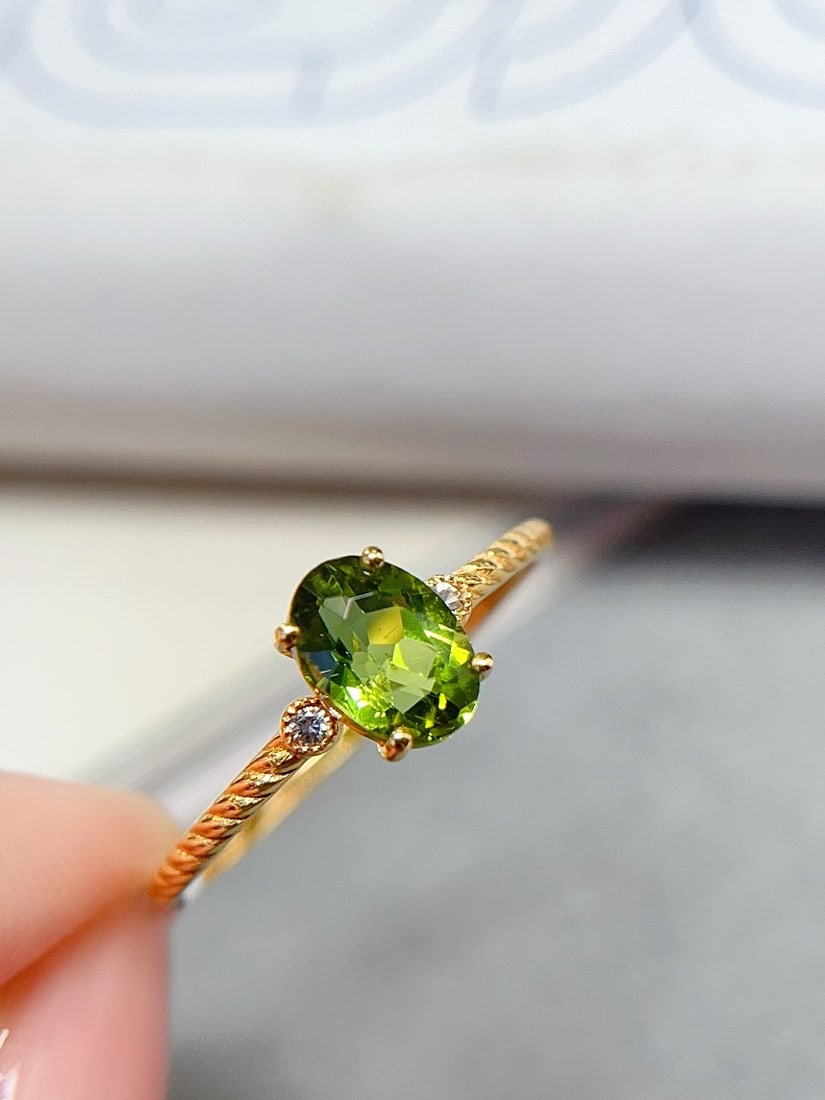18K Gold Green Tourmaline Ring: This ring is crafted in 18K gold, featuring a flawless glassy green tourmaline that exudes unparalleled purity and brilliance. The twisted band design is simple yet exquisite, adding a unique artistic