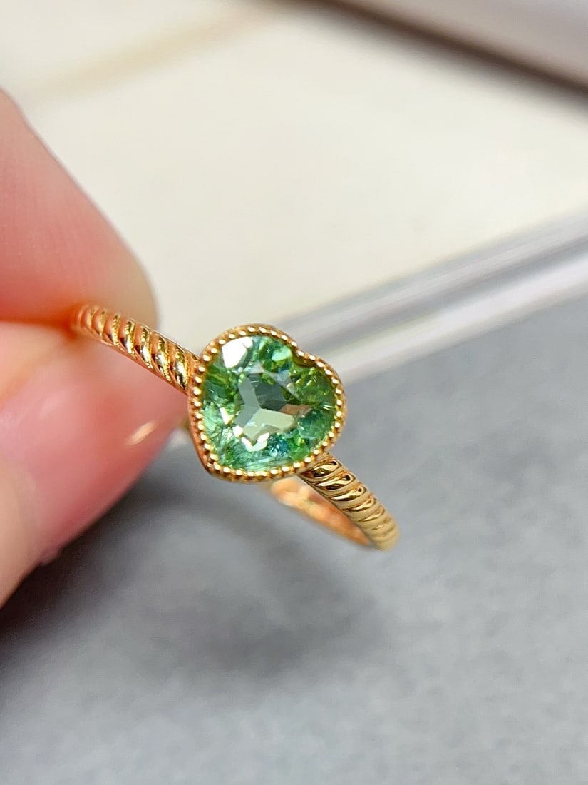 18K Gold Tourmaline Ring: This ring is crafted in 18K gold, featuring a heart-shaped cut tourmaline with a refreshing mint green hue. The minimalist design perfectly highlights the unique charm of the main stone. (Main stone a