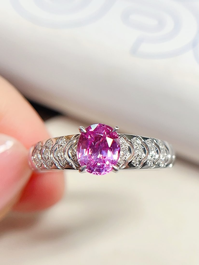 18K Gold Sapphire Ring: This ring is meticulously crafted in 18K gold, featuring a captivating sapphire that exudes unique brilliance. The glassy texture of the pink sapphire complements the 24 diamonds, creating an elegant 