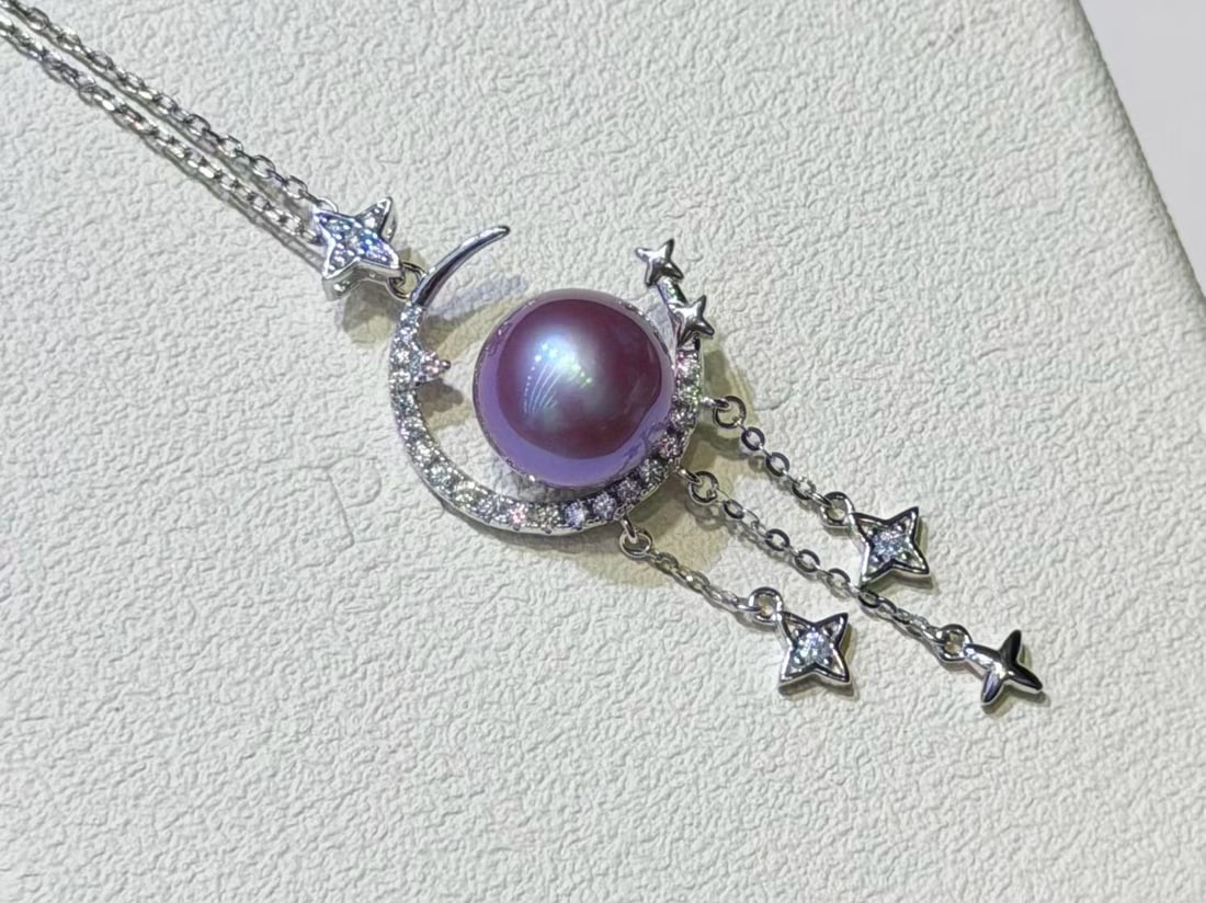 Sterling Silver Slightly Flawed Edison Pearl Pendant: This pendant features a sterling silver base paired with a 10-11mm Edison pearl, showcasing a slightly flawed yet high luster charm. The roundness of the pearl complements the sheen of the silver, mak