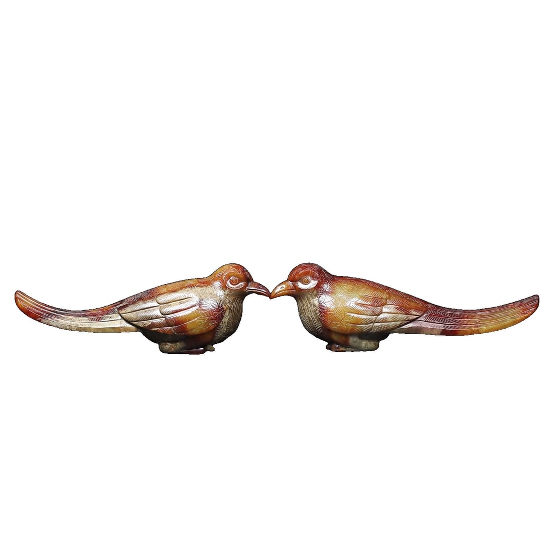 Pair of Hetian Jade Birds: This pair of Hetian jade birds showcases exquisite craftsmanship and a rich patina, with intricate details that reflect the charm of traditional artistry. Their lively forms symbolize good fortune, ma