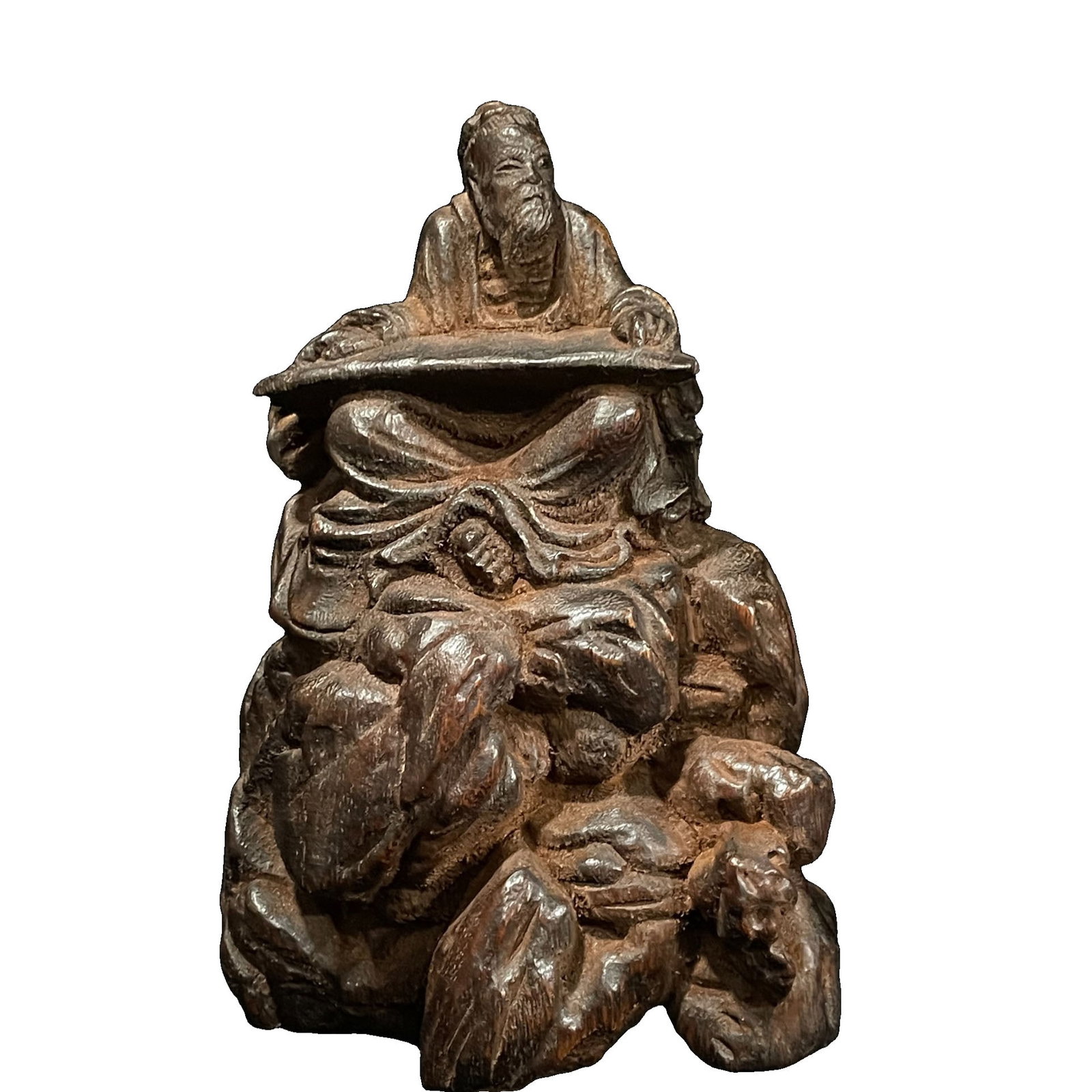 Precious Old Agarwood Carved Zither Figurine: This precious old agarwood carving depicts an elderly figure seated on a rocky outcrop, cradling a zither, with a dignified long beard and naturally folded robes. The surrounding rugged stones enhance