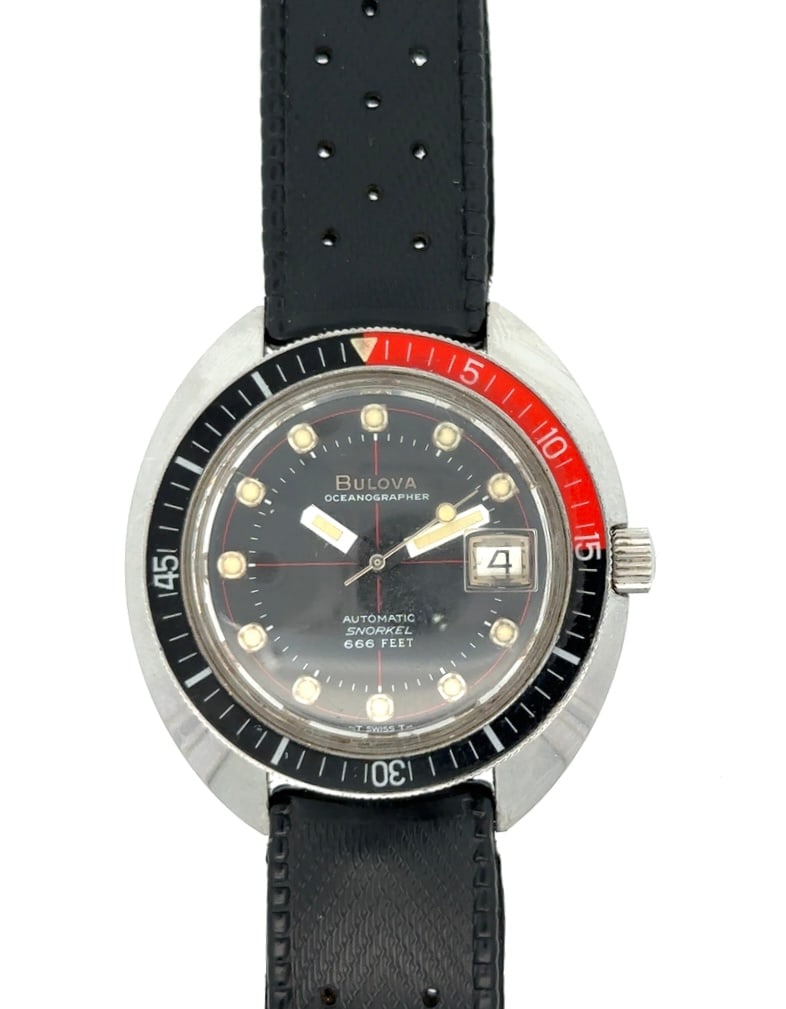 BULOVA OCEANOGRAPHER SNORKEL DIVERS WRISTWATCH, CIRCA 1970: Bulova Oceanographer Snorkel Divers Wristwatch Circa 1970 In Stainless Steel Case With Rotating Red and Black Bezel. The watch has a 21 jewel automatic movement. The watch has a black dial with date a