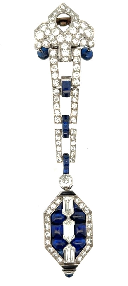 CARTIER PLATINUM DIAMOND AND SAPPHIRE WATCH: Exceptionally Fine Cartier Diamond and Sapphire Ladies Platinum Lapel Watch. The watch is signed Cartier on the dial and the platiunum watch case has French stamps set with 84 round diamonds, 2 bullet