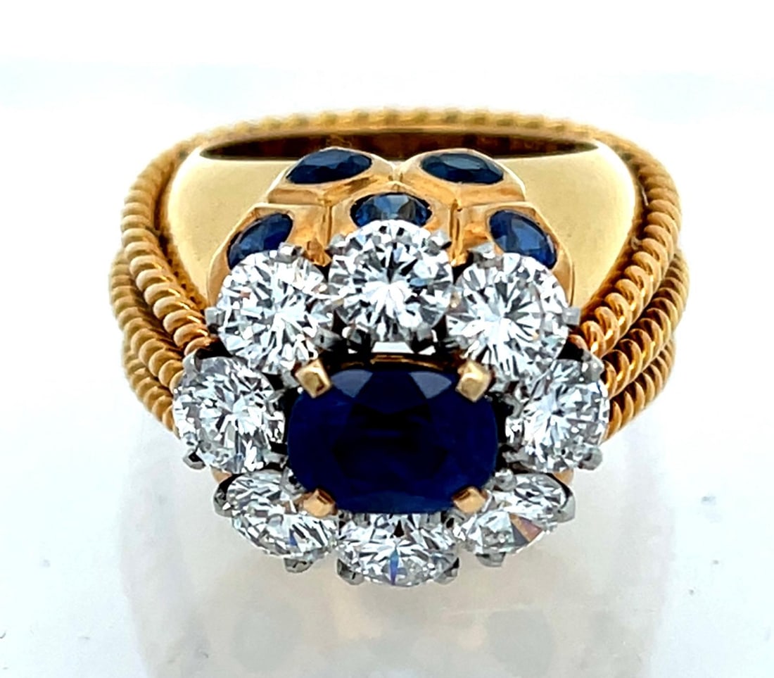 CARTIER PARIS KASHMIR SAPPHIRE AND DIAMOND 18K GOLD AND PLATINUM LADIES RING, CIRCA 1946: Rare and Important Cartier Paris Ladies Ring in 18K Yellow Gold Ring With Sapphires and Diamonds Set In Platinum. The ring has an oval faceted sapphire of Kashmir origin with no treatment and measures