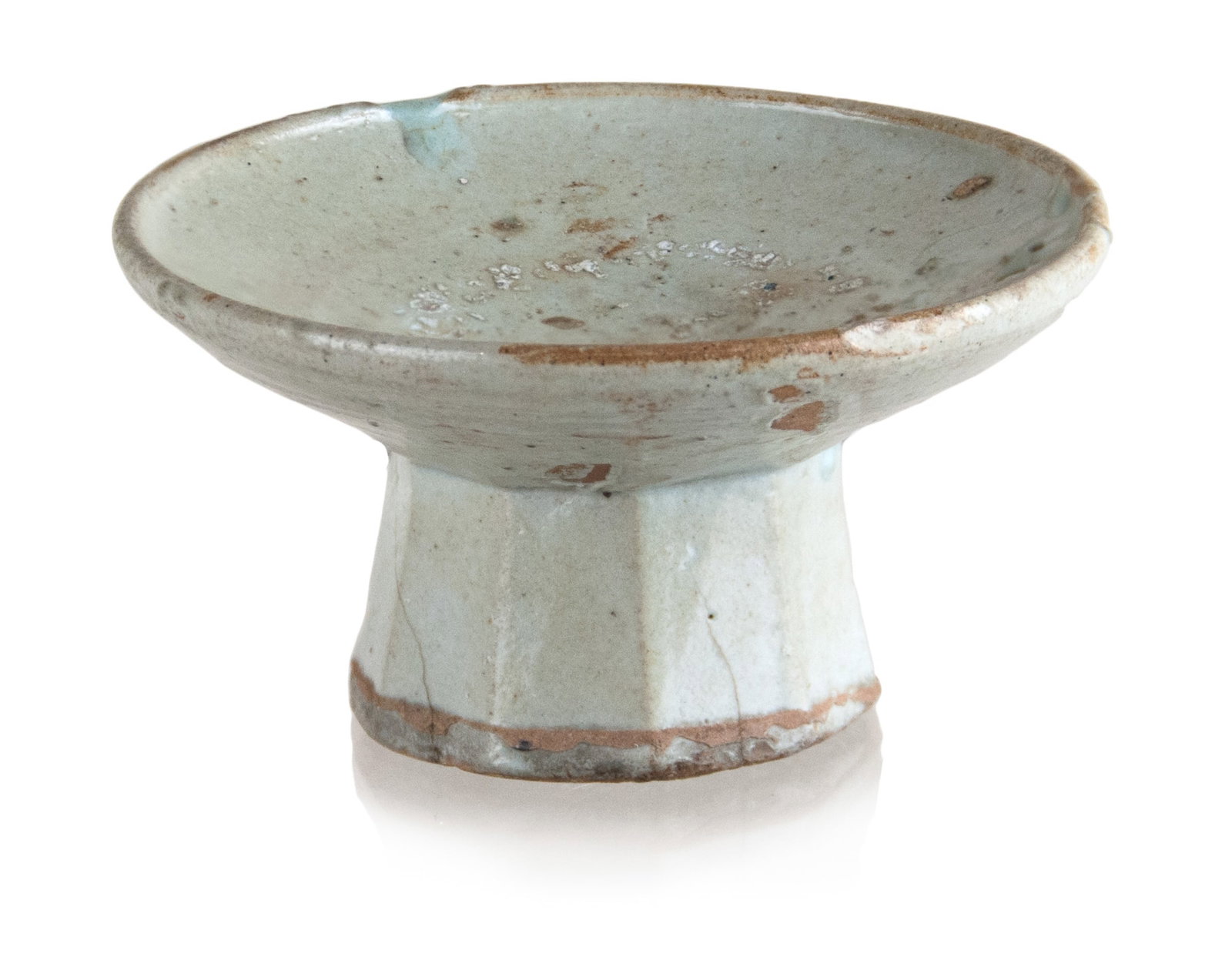 KOREAN RAISED FOOT DISH: A white glazed Korean dish with a raised foot with faceted sides. H:2 3/4in(7cm) D:5in(12.7cm)