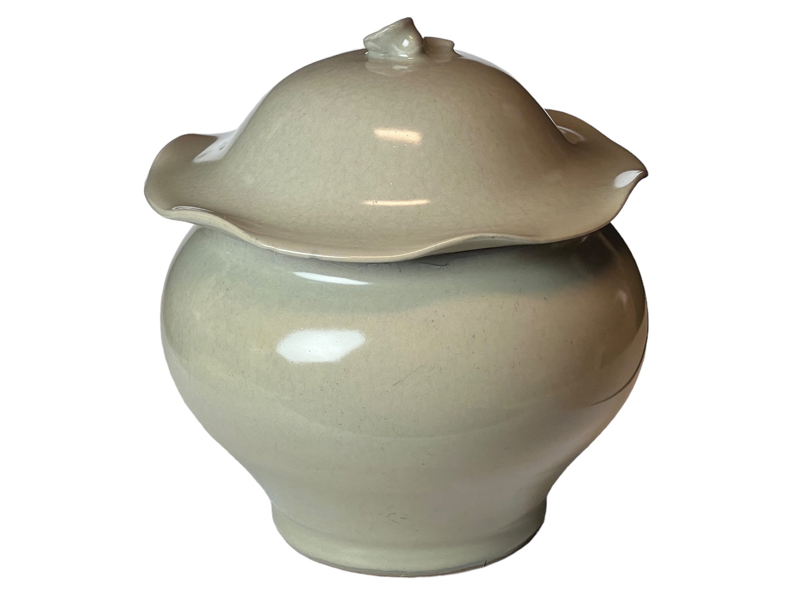 A Chinese Celadon Lotus Jar with Lid: H : 8 1/2 in ( 21.59 cm ) W : 7 1/2 in ( 19.05 cm )