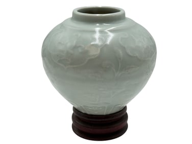 A Chinese Celadon-Glazed Jar with Relief Floral