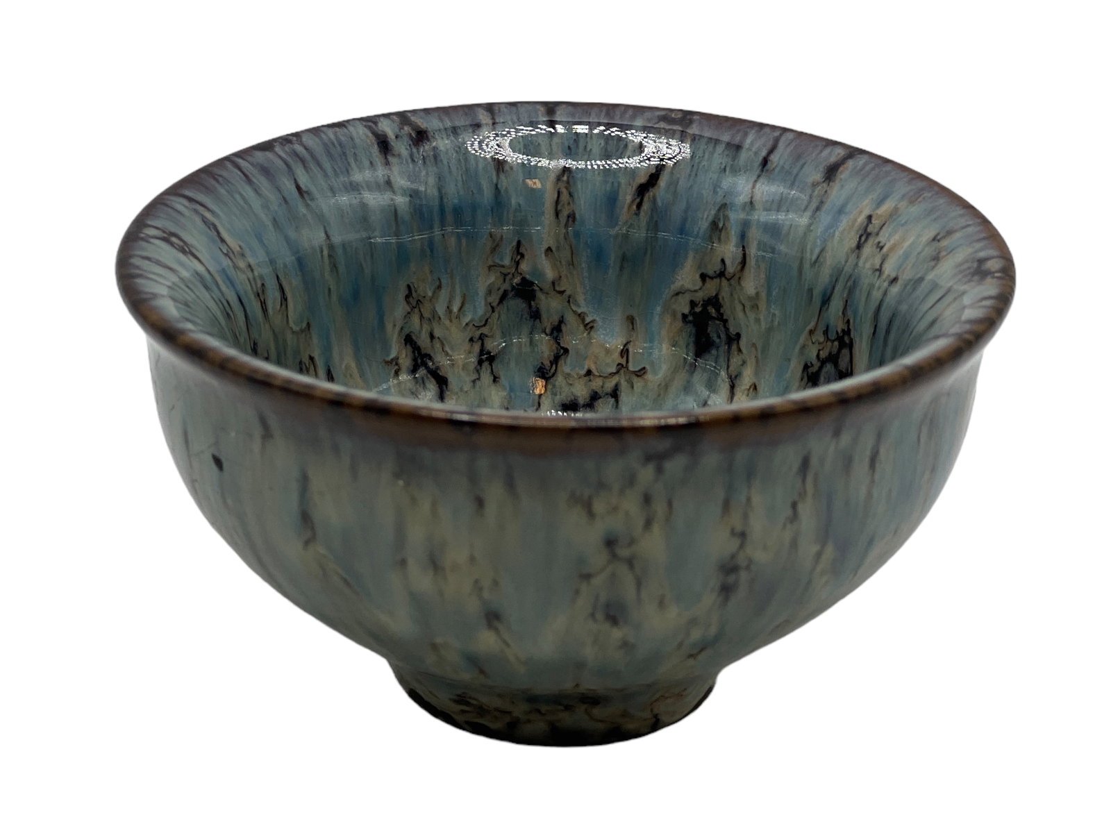 A Porcelain Transforming Tea Cup: H : 1 3/4 in ( 4.45 cm ) W : 3 3/8 in ( 8.57 cm )