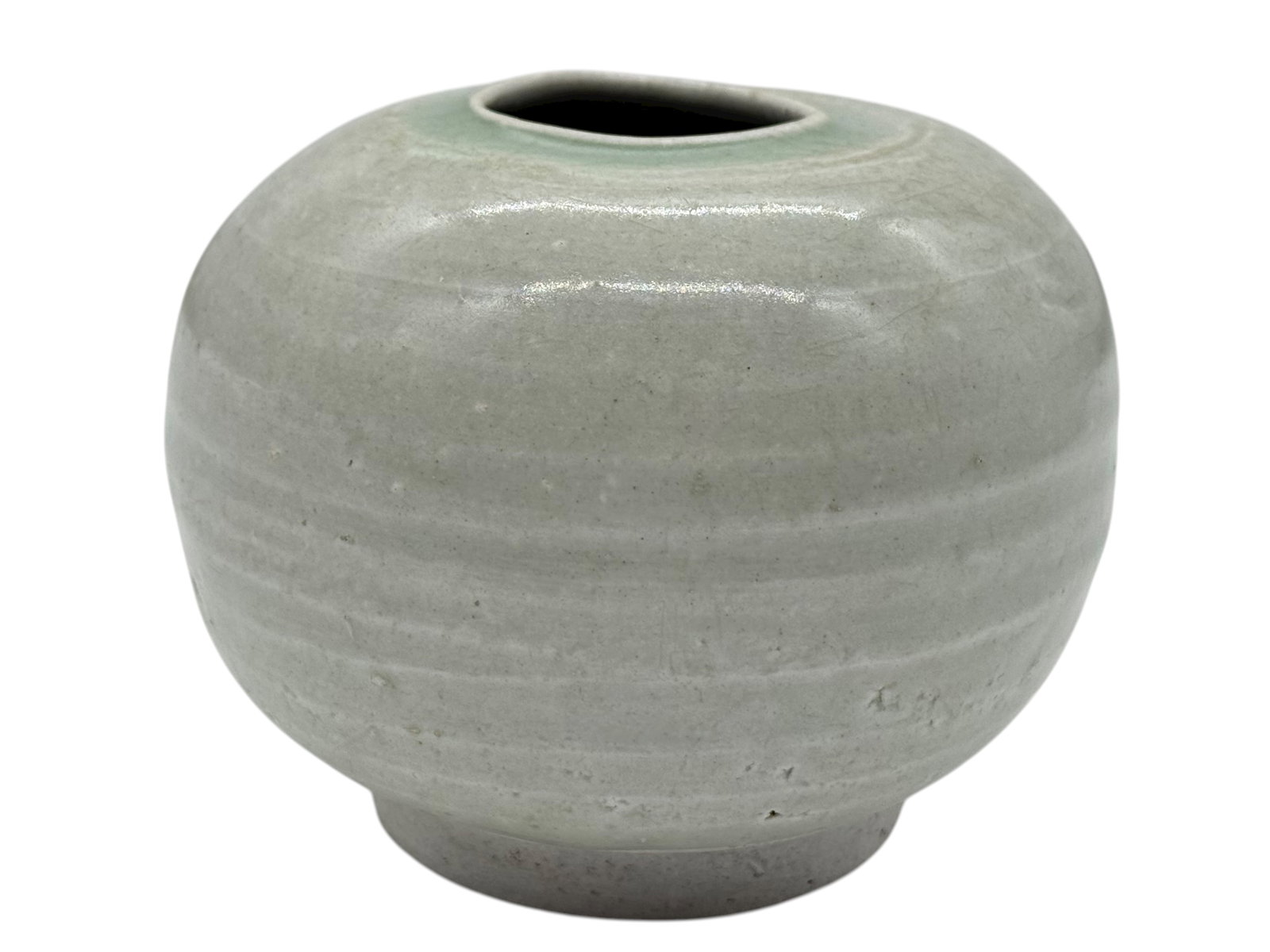 A Chinese Pale Celadon-Glazed Pottery Jar: H: 3 1/2 inches W: 4 1/2 inches
