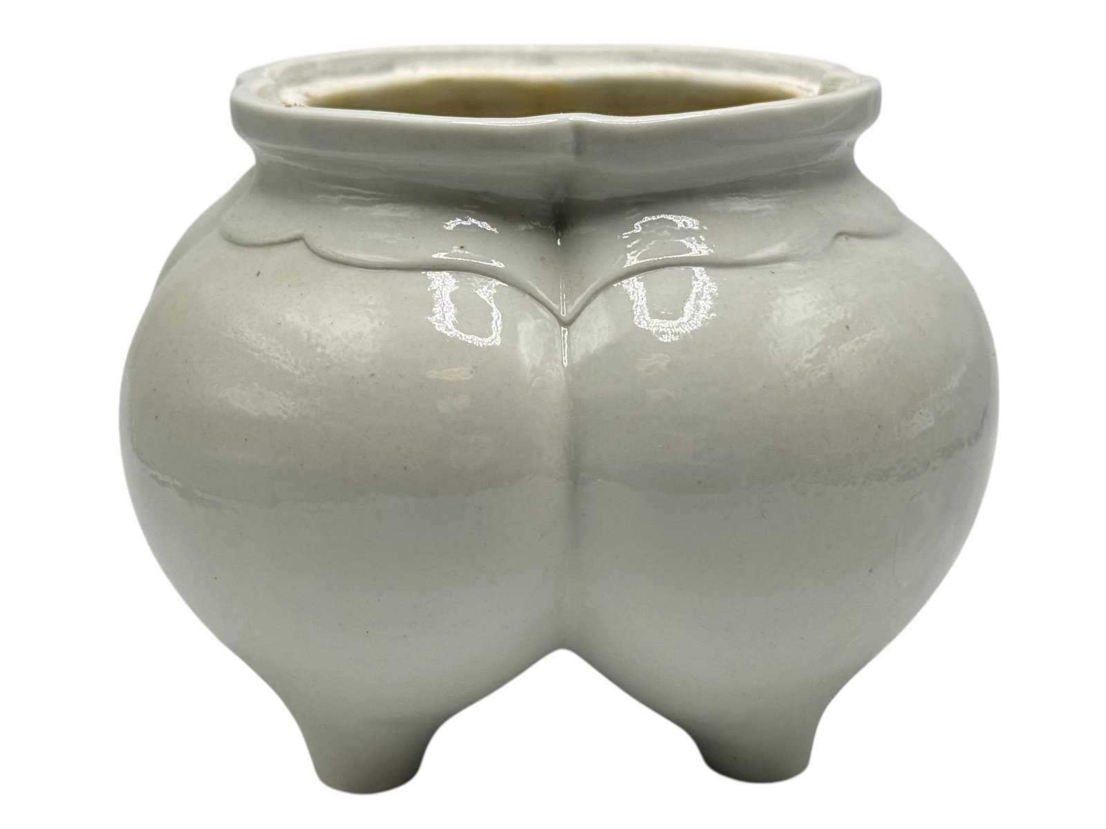 A Chinese White-Glazed Censer: Formed with a compressed body on four short legs, with foliate rim details. H: 3 5/8 inches W: 5 inches