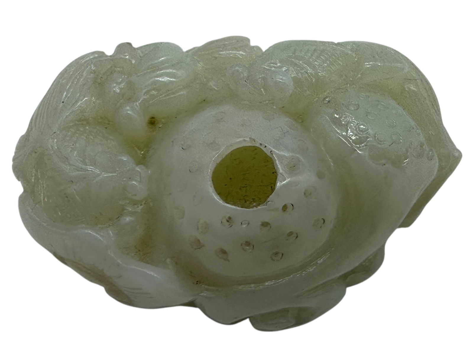 A Chinese Pale Celadon Jade Carved Brush Washer: Carved in the form of a recumbent mythical beast, the body hollowed as a shallow basin with a central well and small drainage perforations. The exterior carved in low relief with stylized mane, 