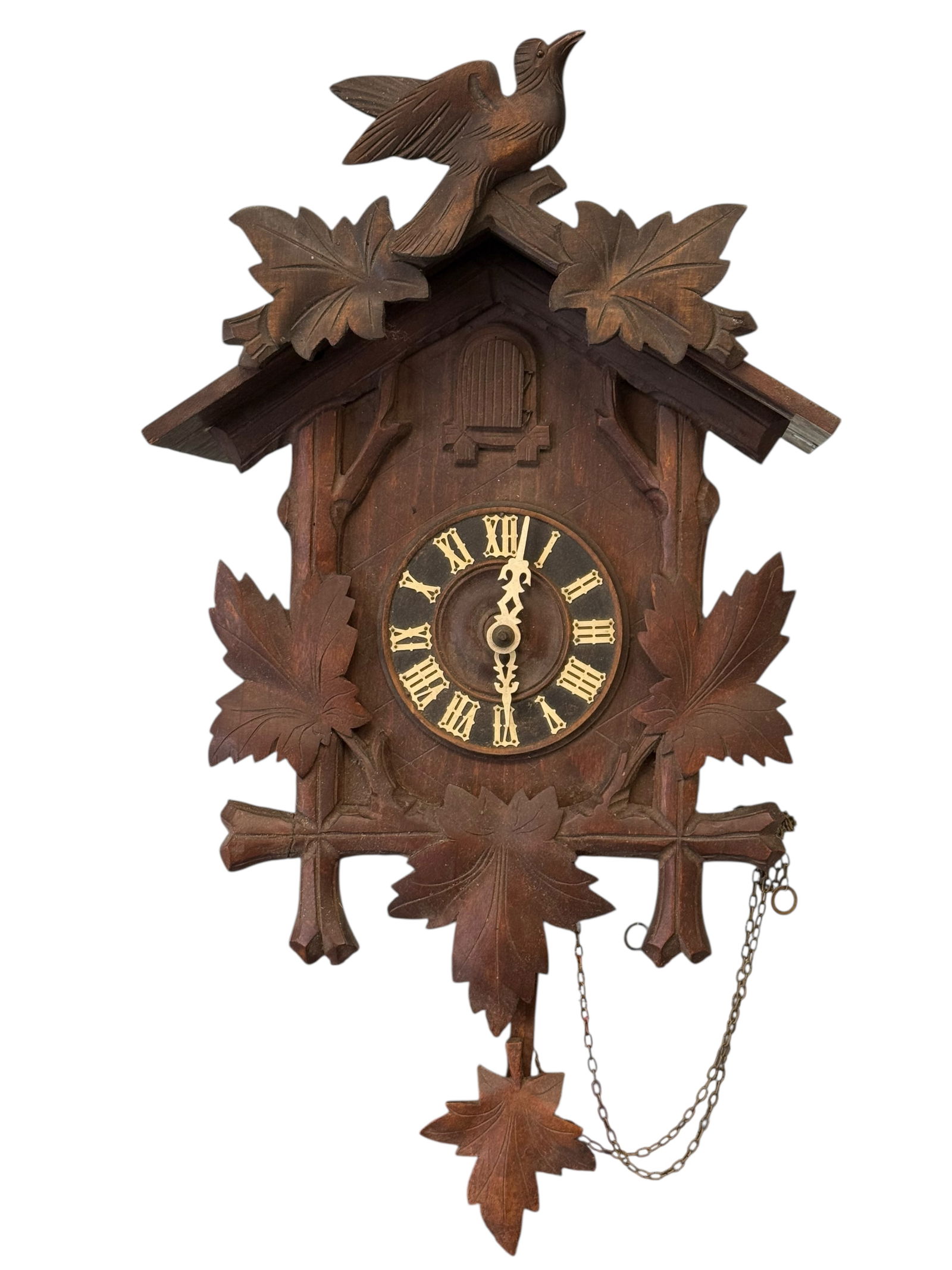 A German Carved Wood Cuckoo Clock: H: 17 3/4 inches W: 12 inches D: 7 inches