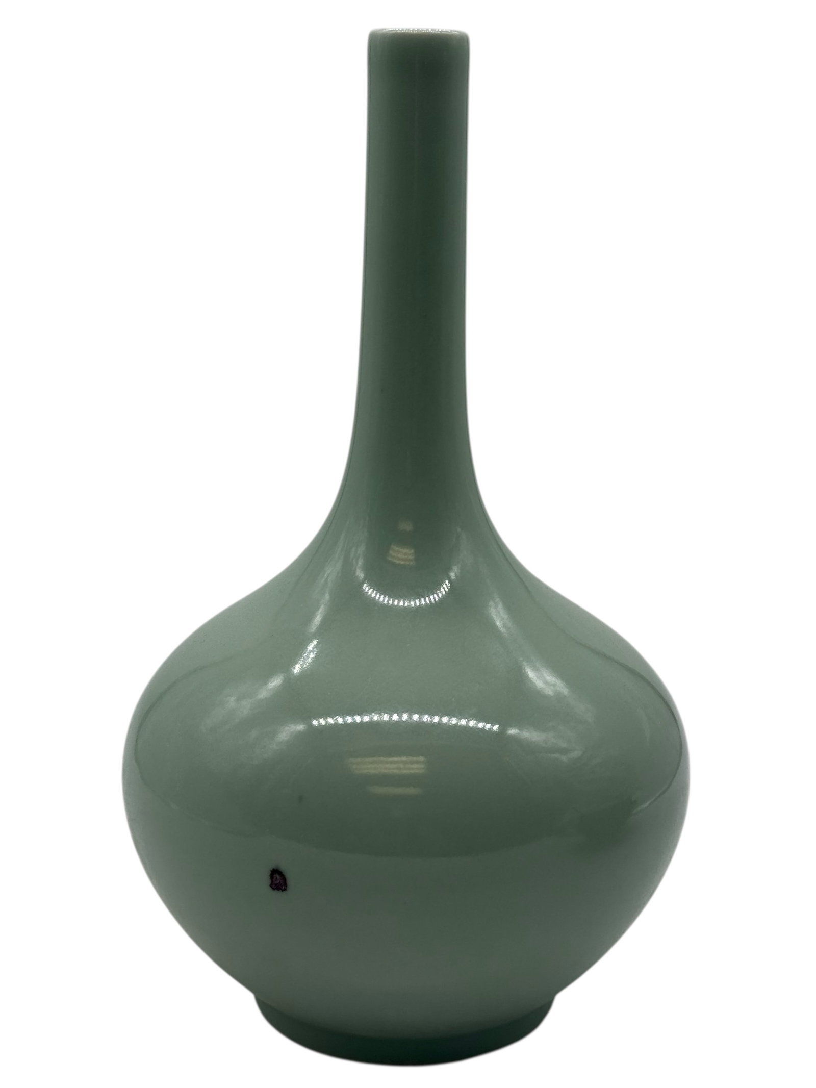 A Chinese Celadon-Glazed Vase: The pear-shaped body rising to a tall cylindrical neck, covered overall with a pale green celadon glaze, H: 12 inches W: 6 1/2 inches