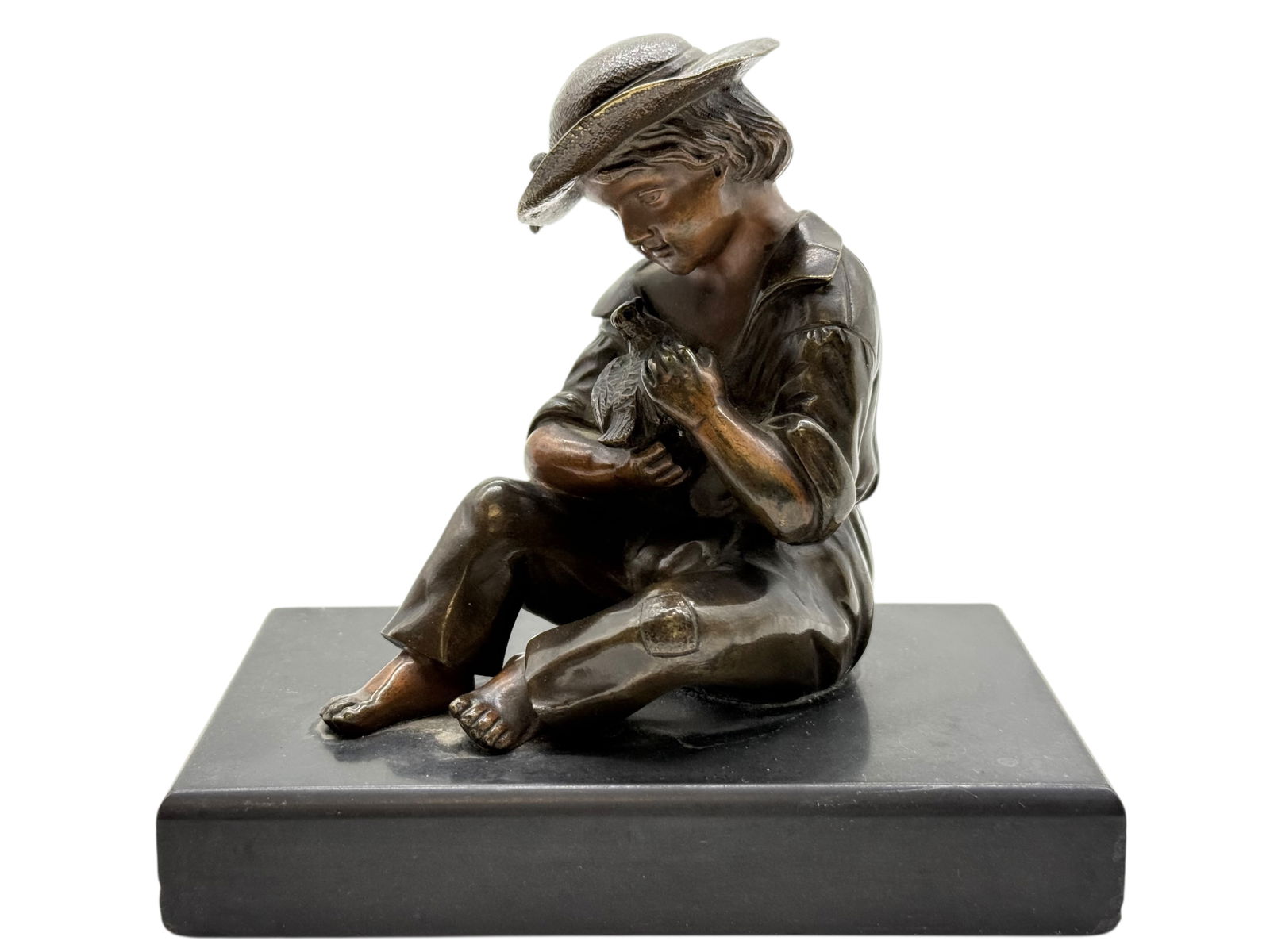 A European Bronze Figure of a Seated Child Holding: A European Bronze Figure of a Seated Child Holding a Bird H: 4 3/4 inches W: 5 inches D: 3 inches