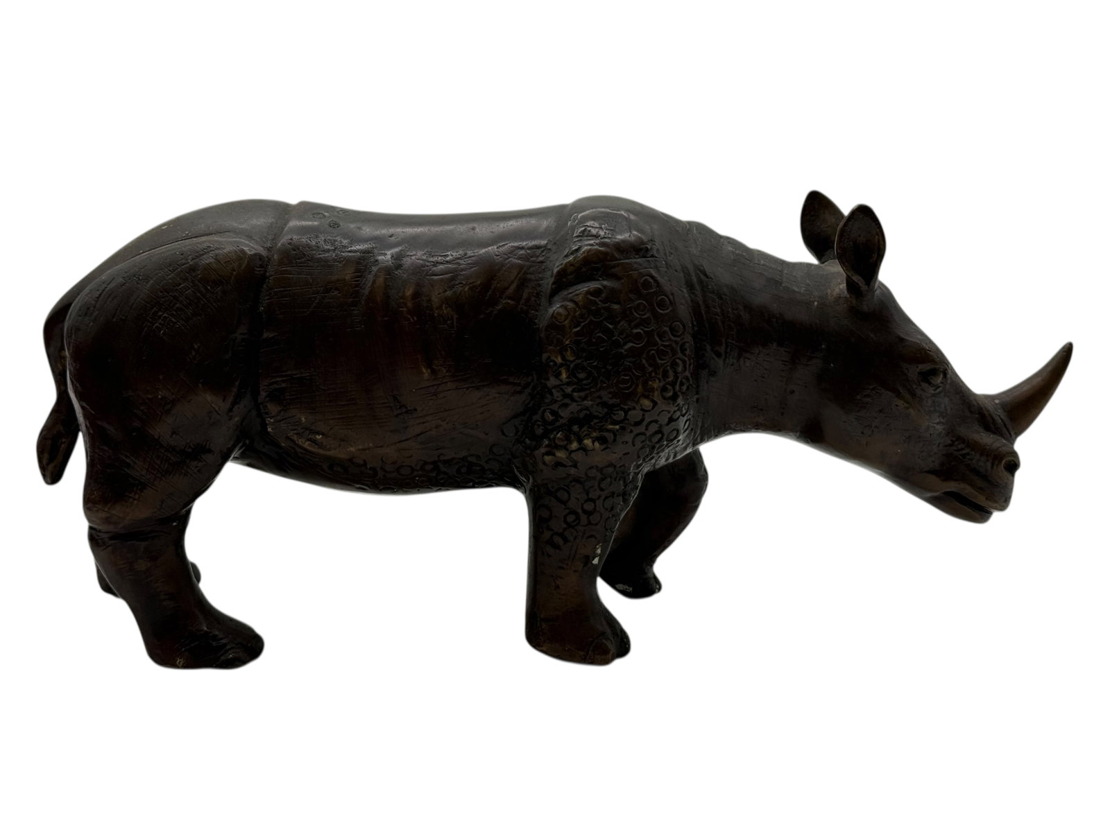 A Bronze of a Rhinoceros: H: 5 3/4 inches L: 14 inches D: 3 1/2 inches