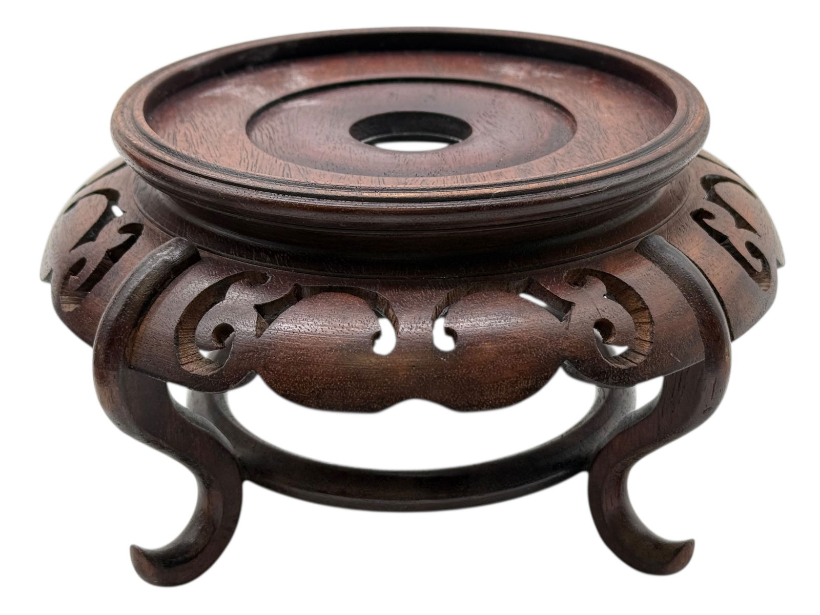 A Chinese Hardwood Carved Stand: The circular top raised on an openwork apron and four curved legs, carved with scrolling motifs. H: 4 inches D: 7 1/2 inches