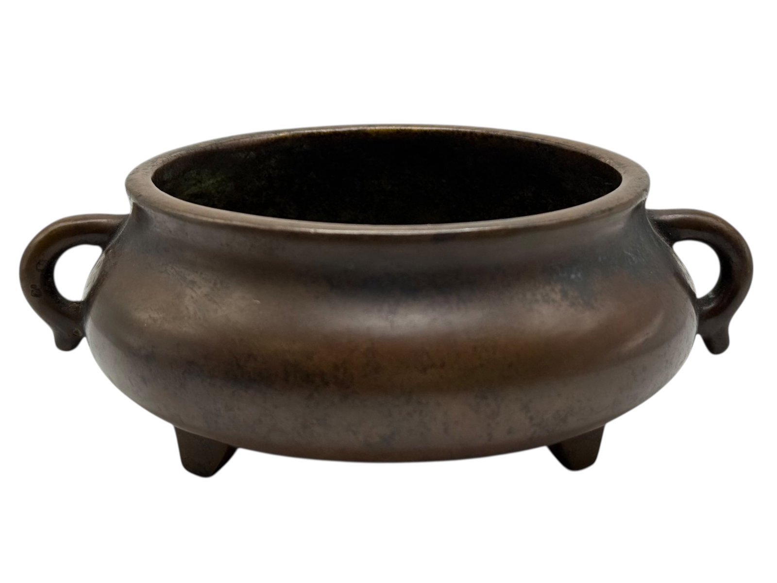 A Chinese Bronze Tripod Censer, Marked: The censer of compressed globular form raised on three short feet, flanked by a pair of loop handles, the surface showing an even brown patina. H: 2 1/4 inches W: 6 inches