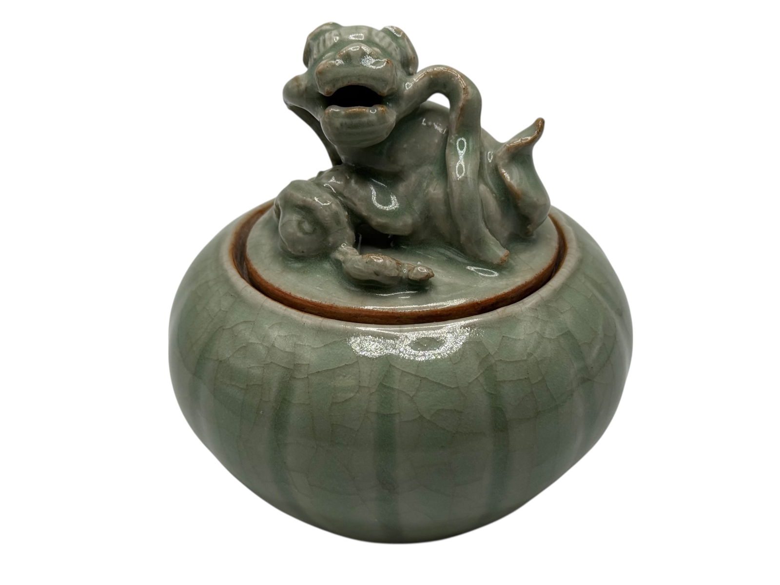 A Chinese Celadon-Glazed Covered Jar with Lion Fin: A Chinese Celadon-Glazed Covered Jar with Lion Finial H: 4 1/4 inches W: 4 inches