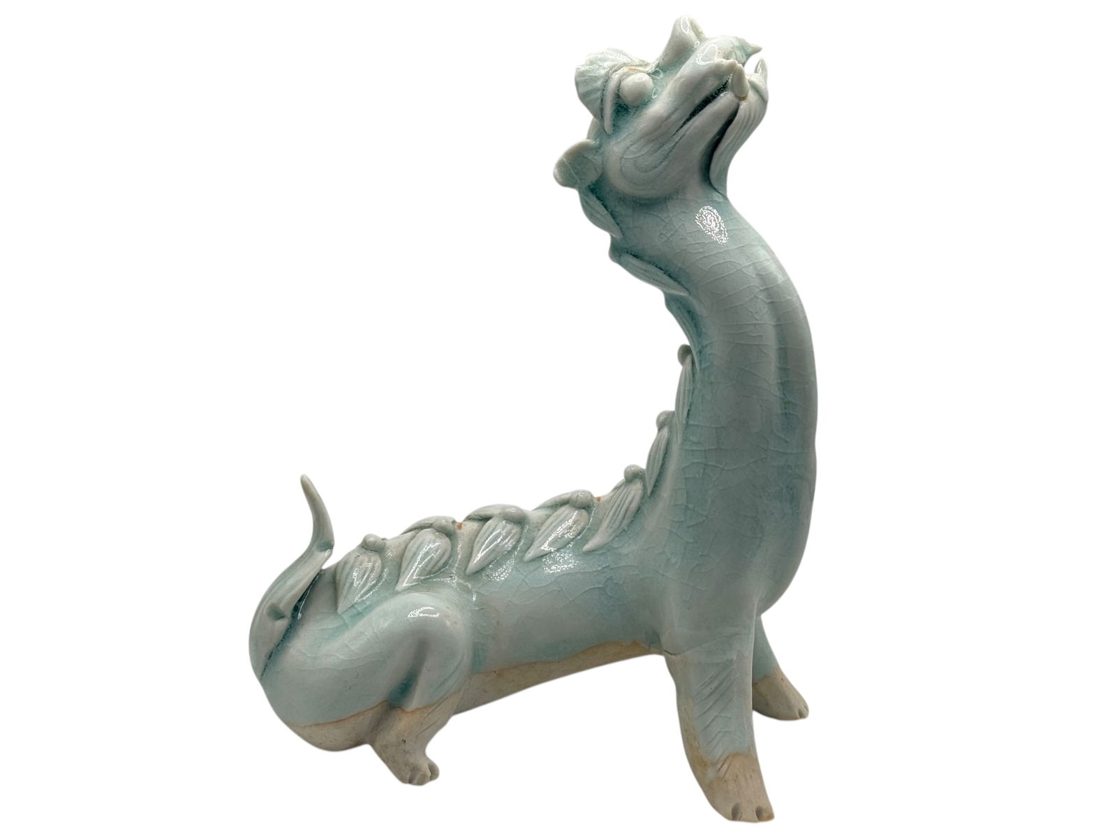 A Chinese Celadon-Glazed Mythical Beast: H: 7 1/2 inches W: 5 3/4 inches