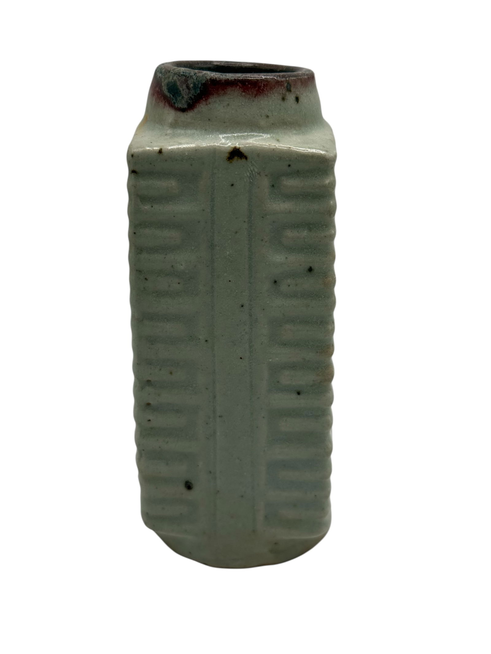 A Chinese Celadon-Glazed Cong Vase: Of tall rectangular form with vertical ribbed panels, covered with a pale celadon glaze with darker pooling near the rim. H: 4 1/4 inches W: 2 1/4 inchesD: 2 1/4 inches