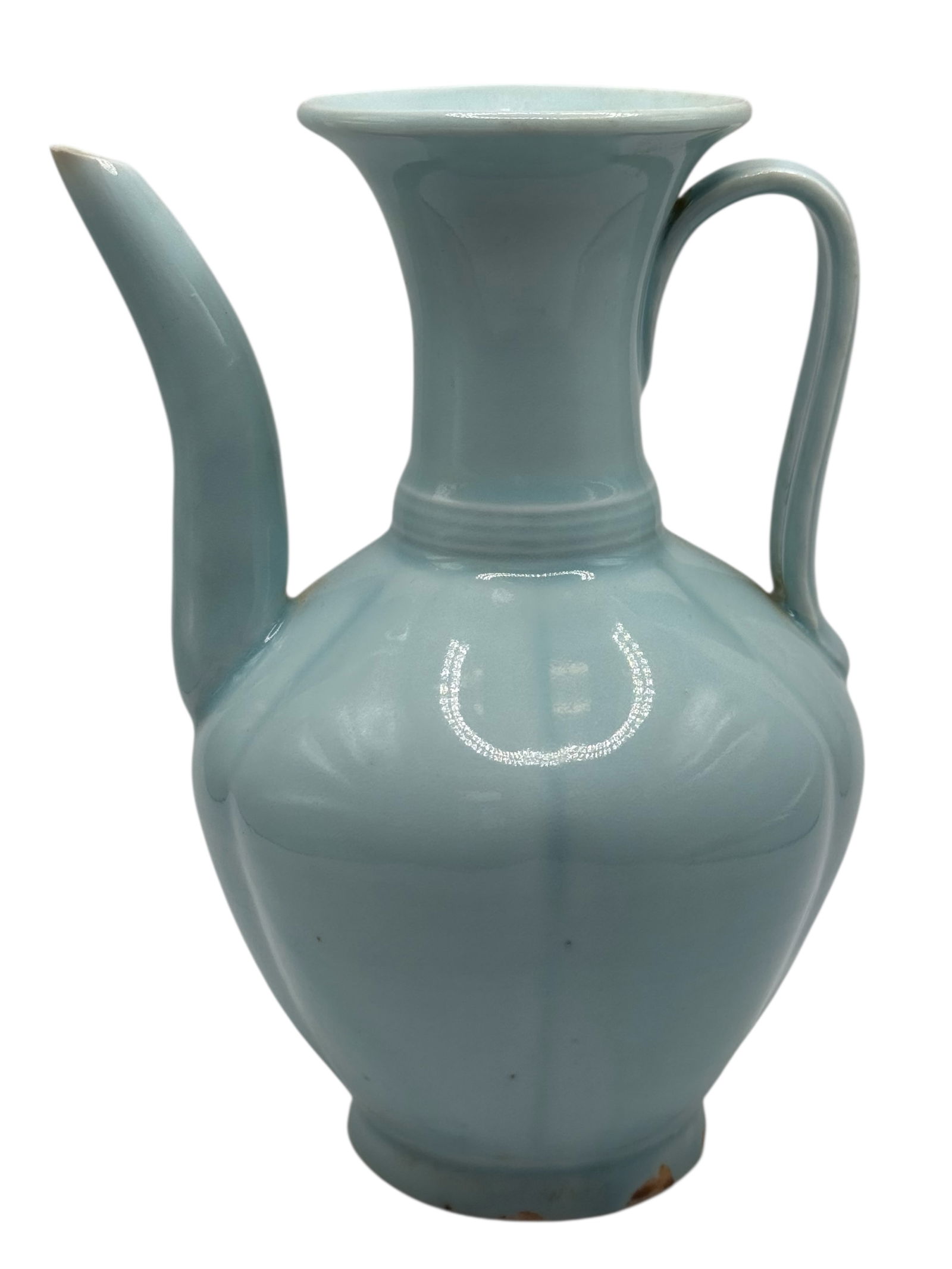 A Chinese Celadon-Glazed Ewer: Of globular body with a flaring neck, fitted with a curved spout and loop handle, covered overall with a pale celadon glaze. H: 7 inches W: 5 inches