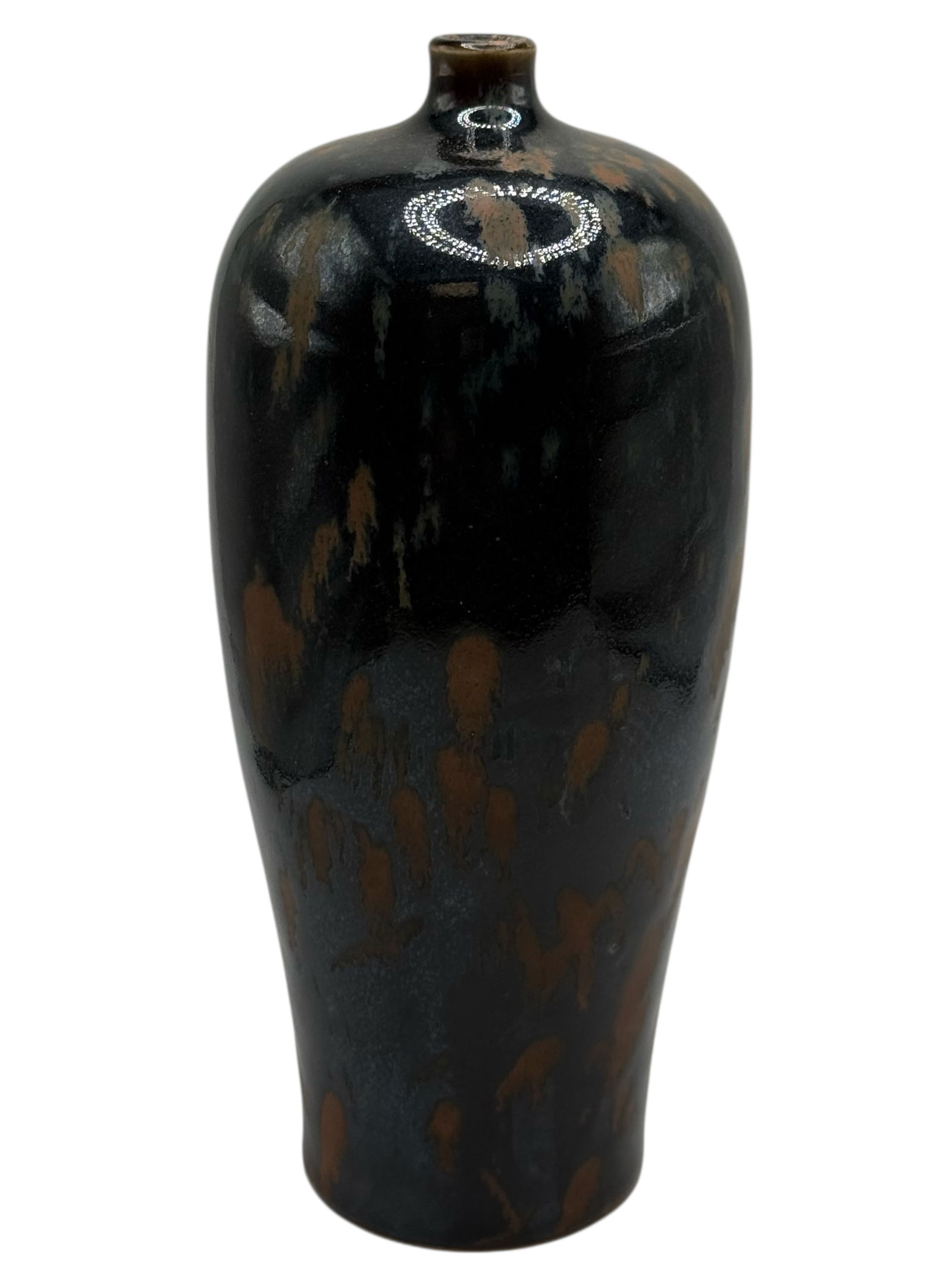 A Chinese Black-Glazed Bottle Vase: Of elongated baluster form, covered with a black glaze with irregular brown splashes and streaks, thinning toward the mouth and foot. H: 8 1/2 inches W: 3 3/4 inches