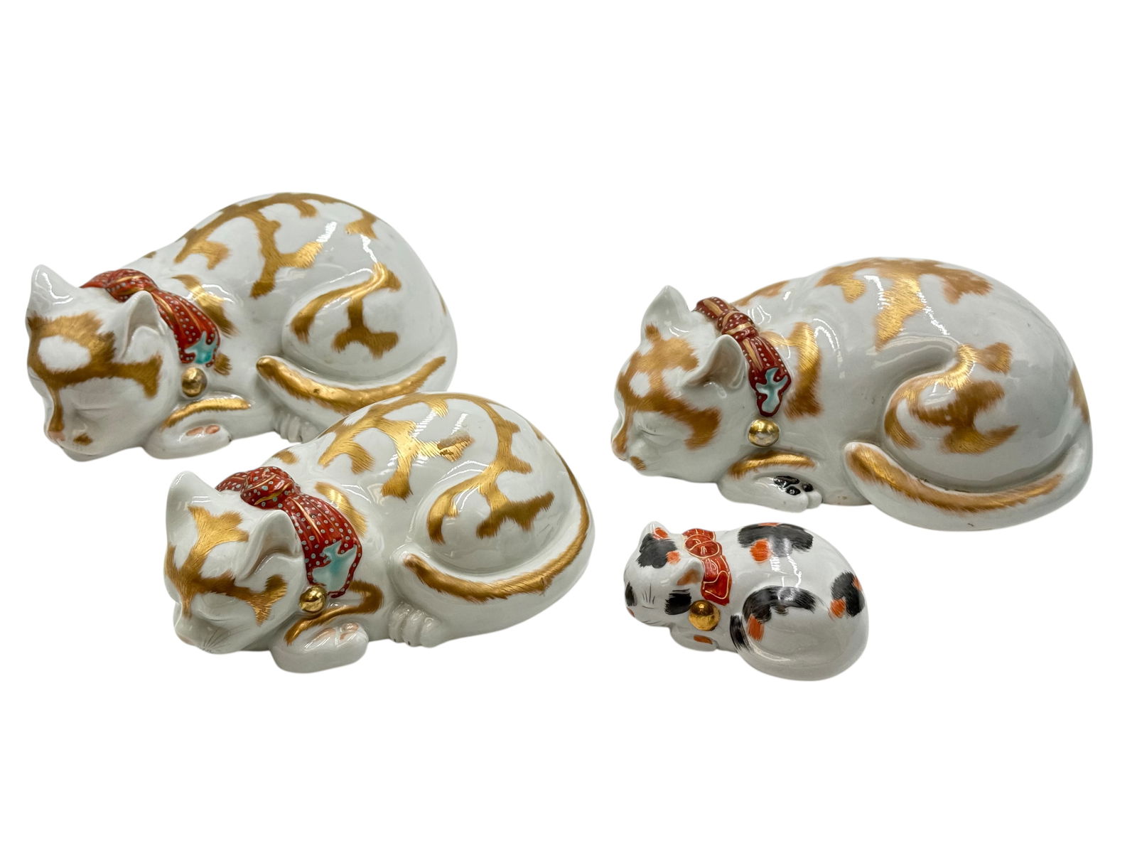 Four Japanese Kutani Porcelain Sleeping Cats: Four Japanese Kutani Porcelain Sleeping Cats – Hand-Painted Gold & Red Collar Figurines H: 3 3/5 inches (8.5 cm) W: 8 1/4 inches(20.9cm) H:2 3/4 inches (6.9cm) W: 7 1/4 inches(18.4 cm)