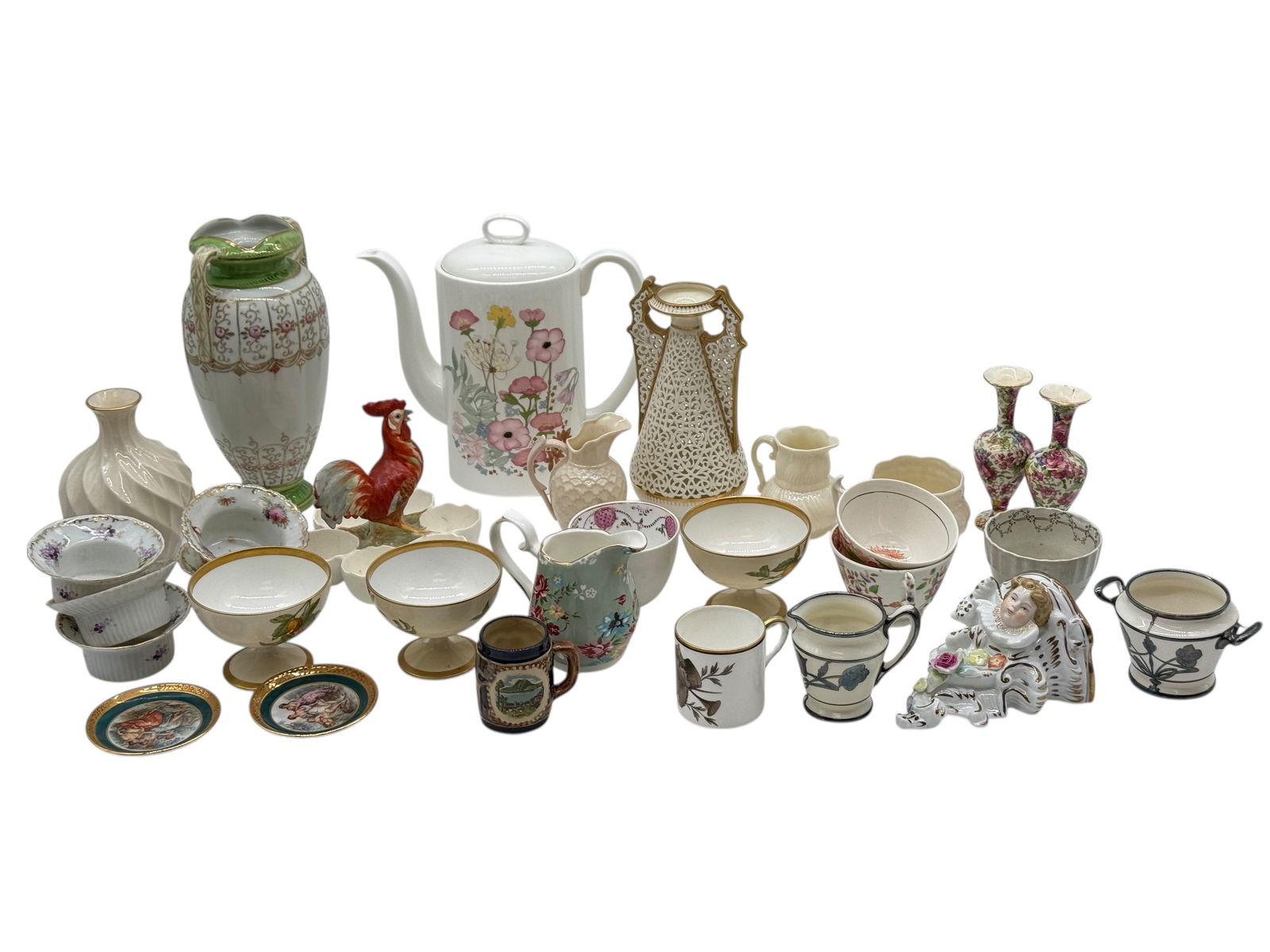 Group Lenox, Belleek, Limoges,Wedgwood Tablewares: Comprising a group of assorted European porcelain tablewares and decorative objects, including vases, bowls, cups, pitchers, a teapot, and figural items, some pieces bearing marks including Lange, Len