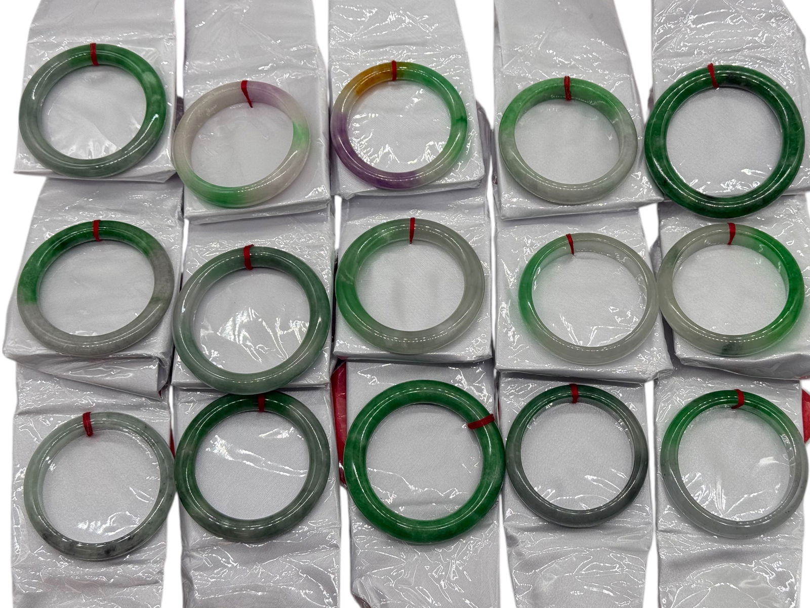 A Group of 31 Chinese Green Stone Bangles: A Group of 31 Chinese Green Stone BanglesAverage Inner : 73 mm Outer : 57 mm